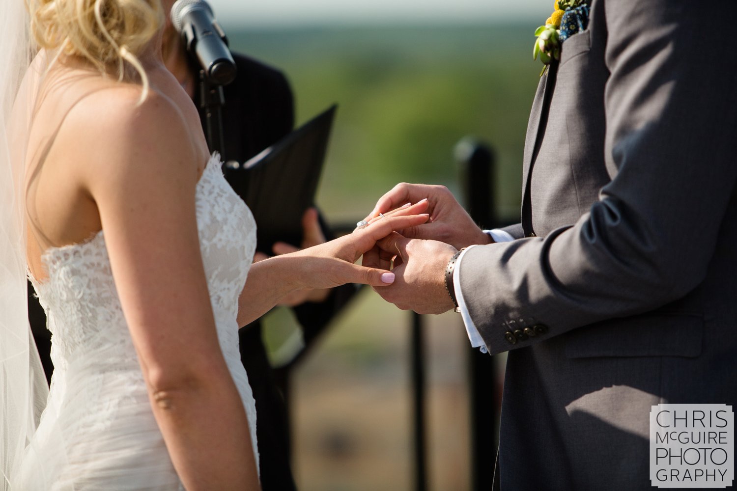 groom placing ring on bride's finger