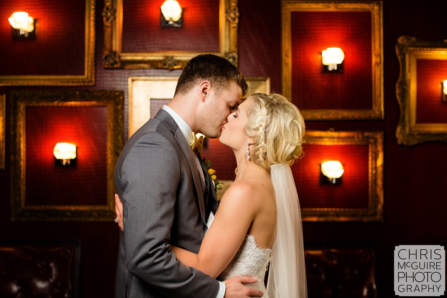 bride groom kiss red wall