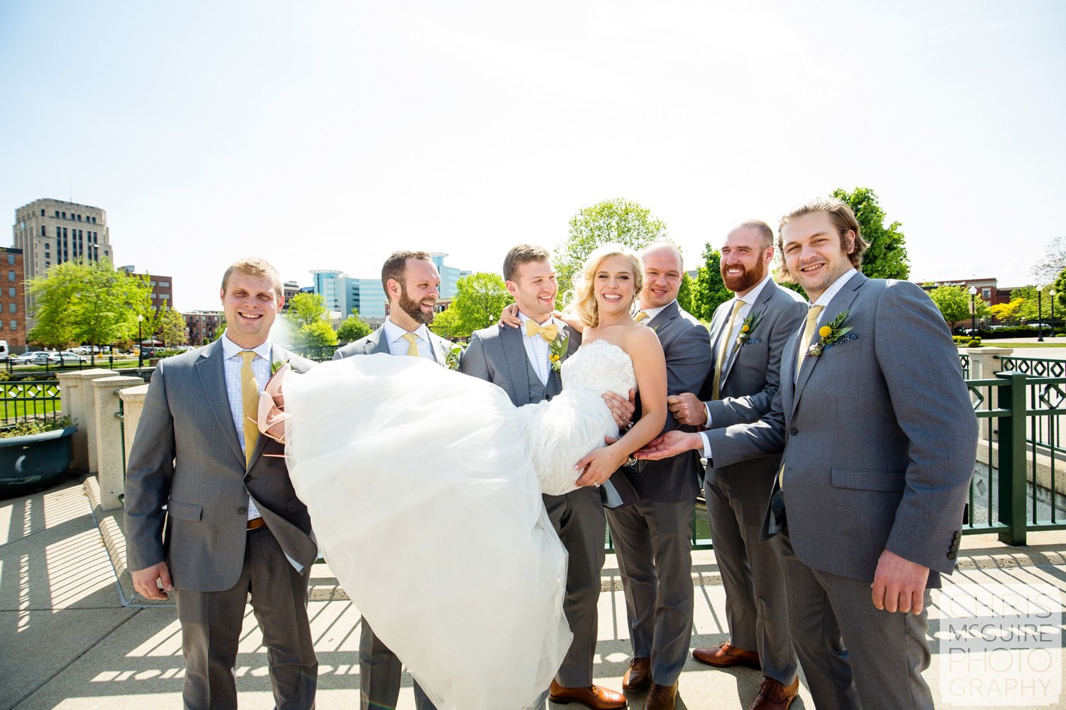 groomsmen carry bride