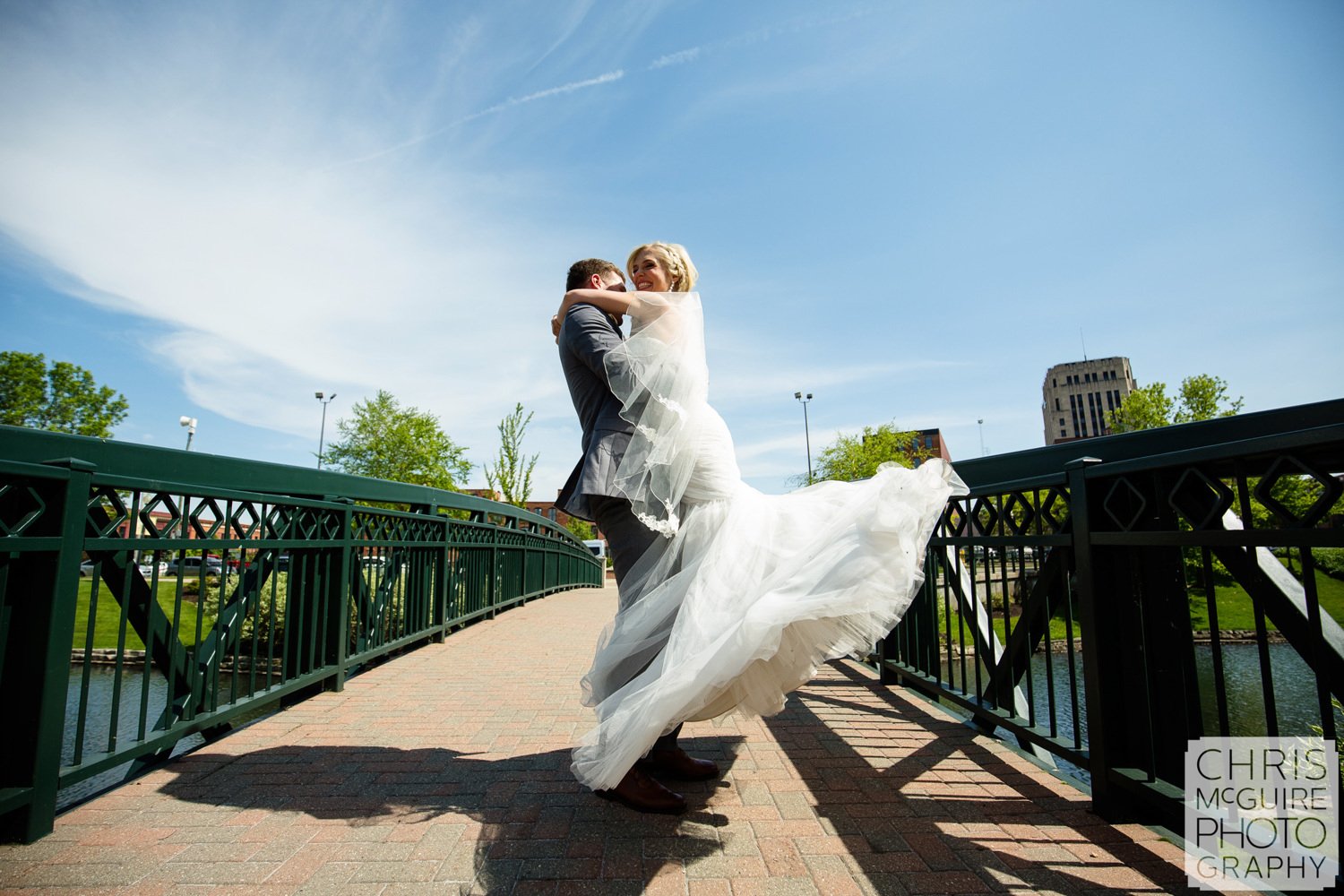 bride groom twirl on bridge