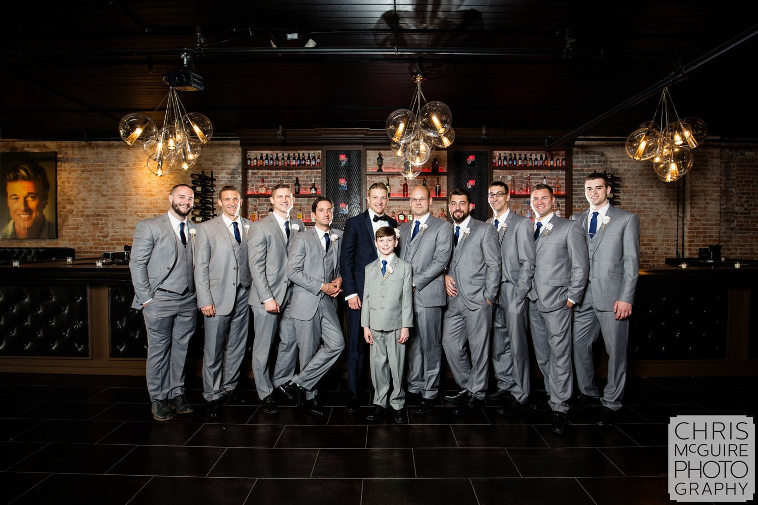 groom and groomsmen posing in bar