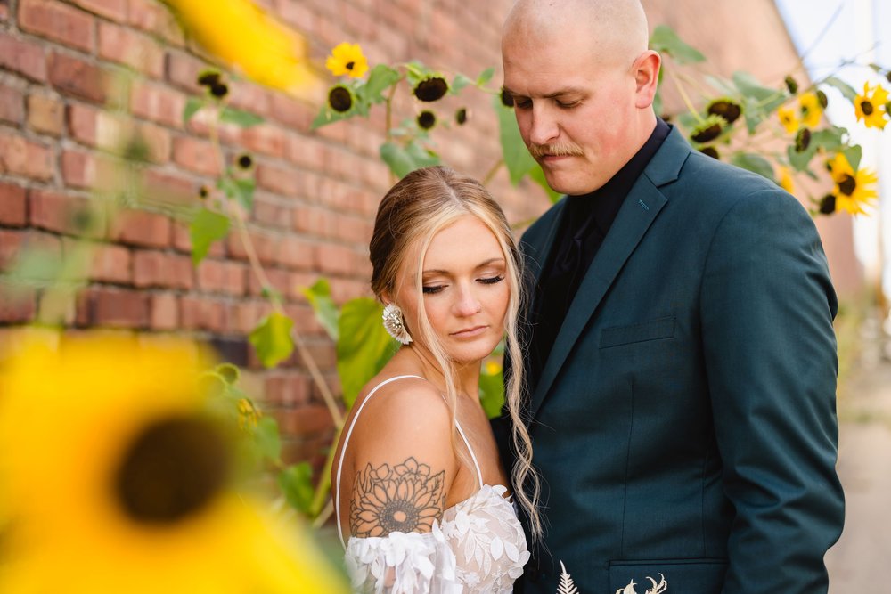 Bride and groom in sunflower alley