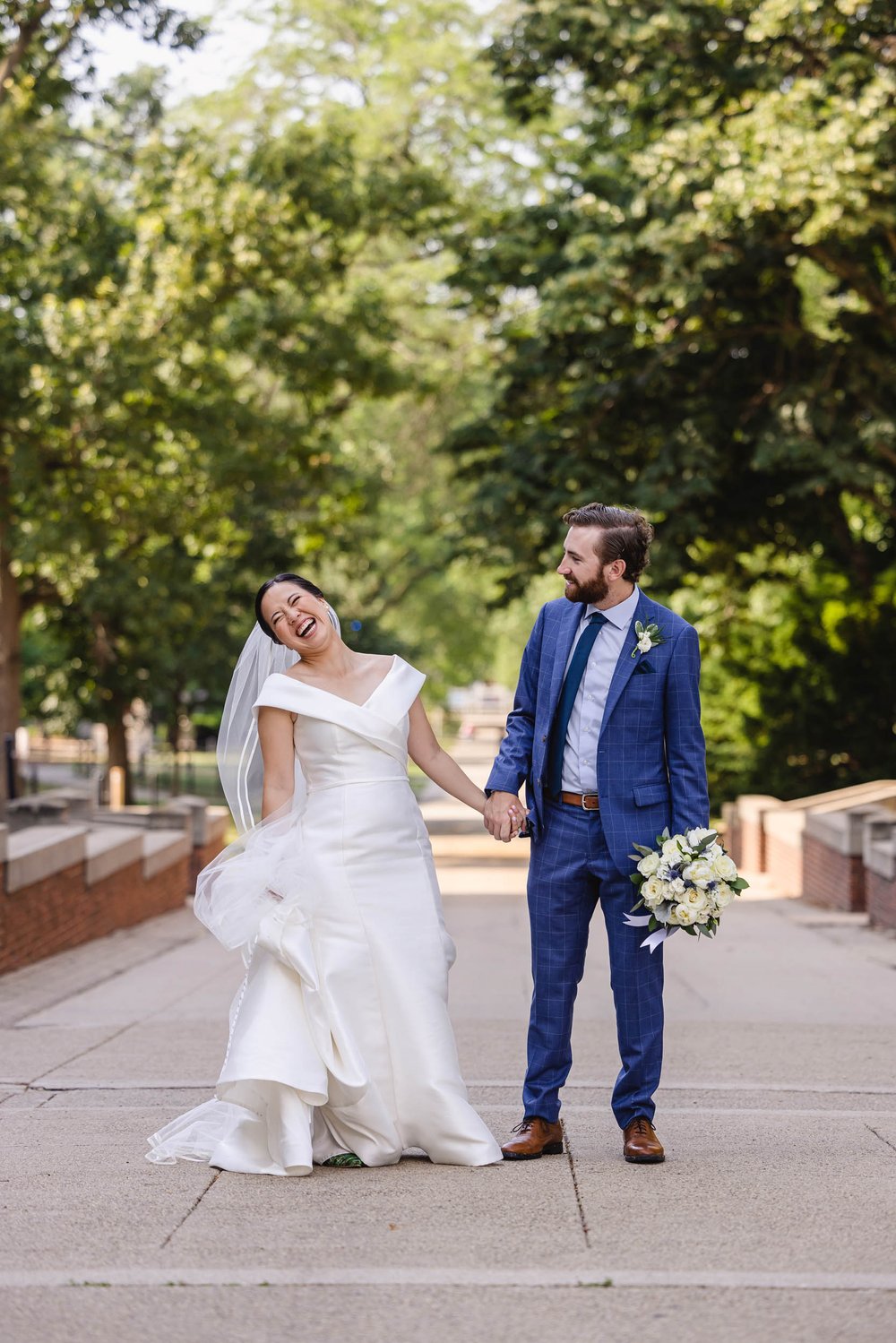 Bride laughs with groom at University of Illinois Wedding
