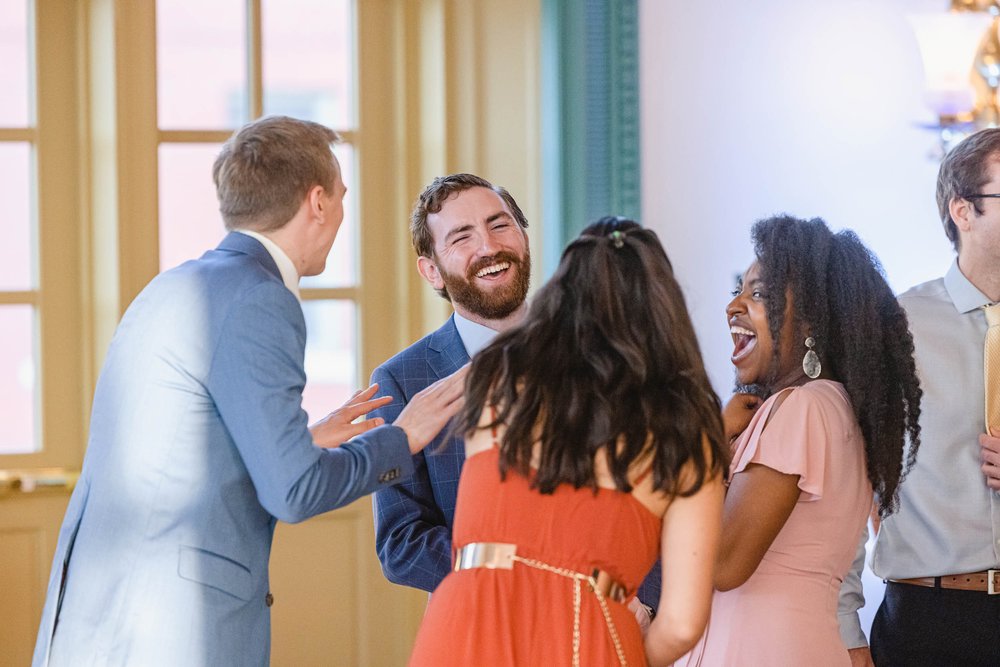 groom laughs at reception