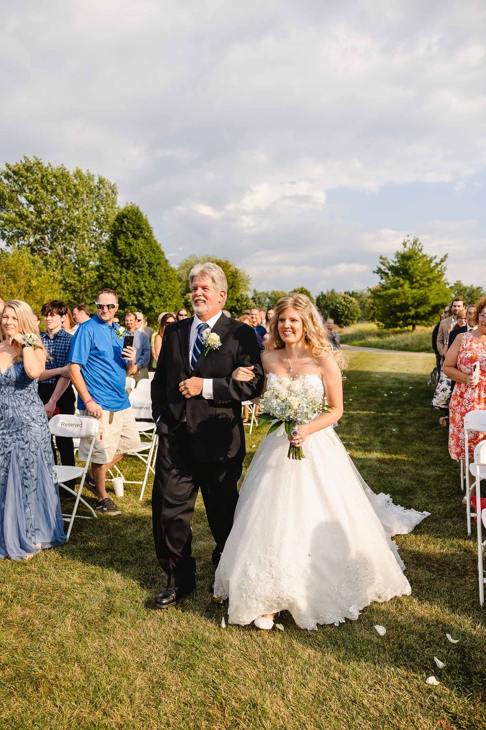 Bride and father walk down aisle at Metamora Fields Wedding