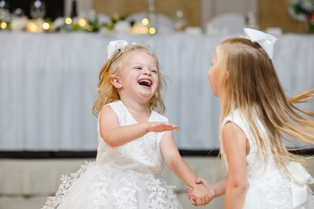 Flower girls dancing and laughing