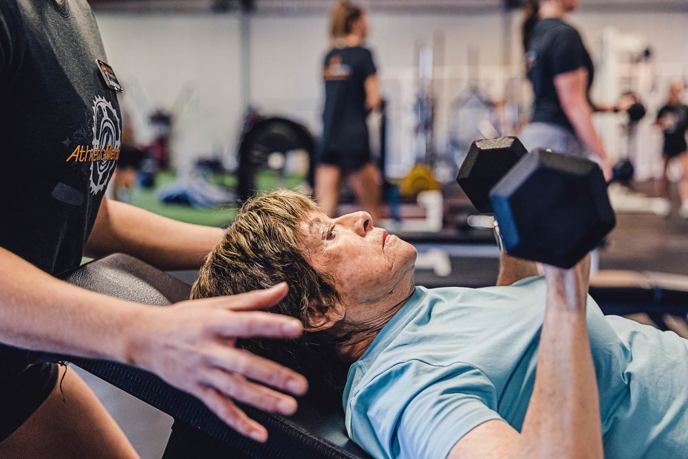Woman working with trainer at gym