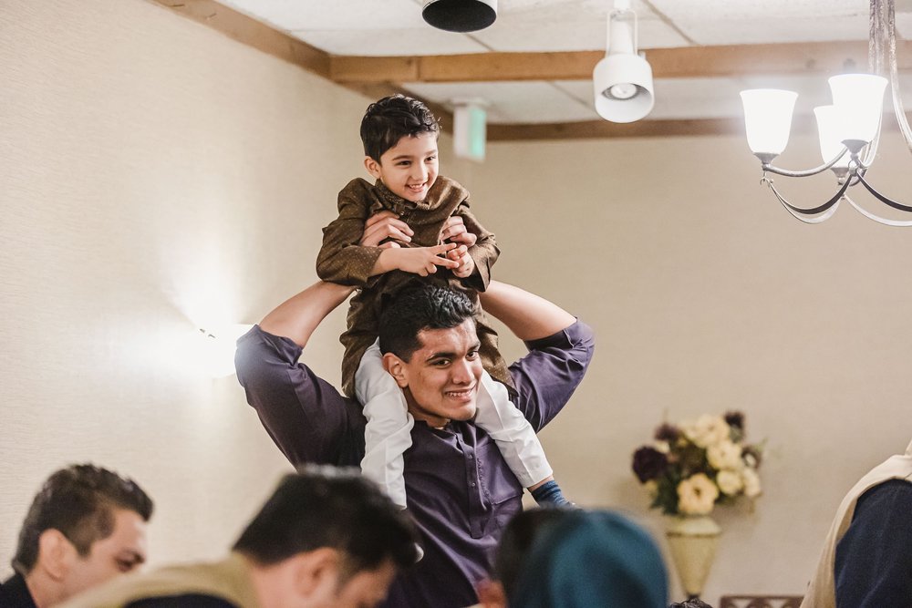 Child on shoulders laughing