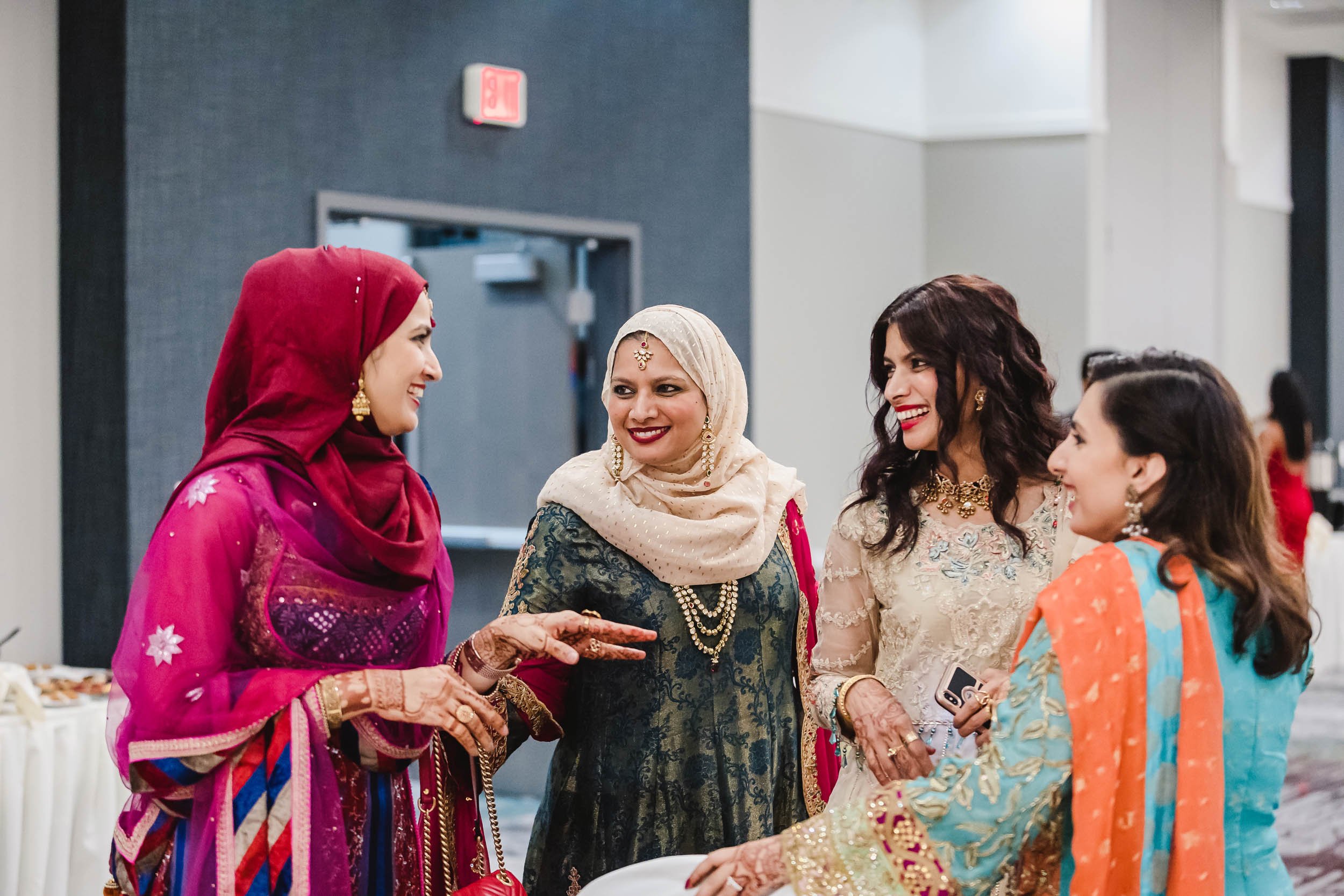 Women chat at wedding reception