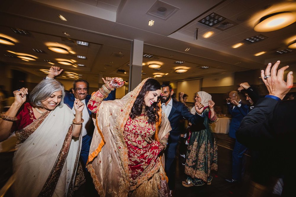 Bride dancing at Muslim wedding reception