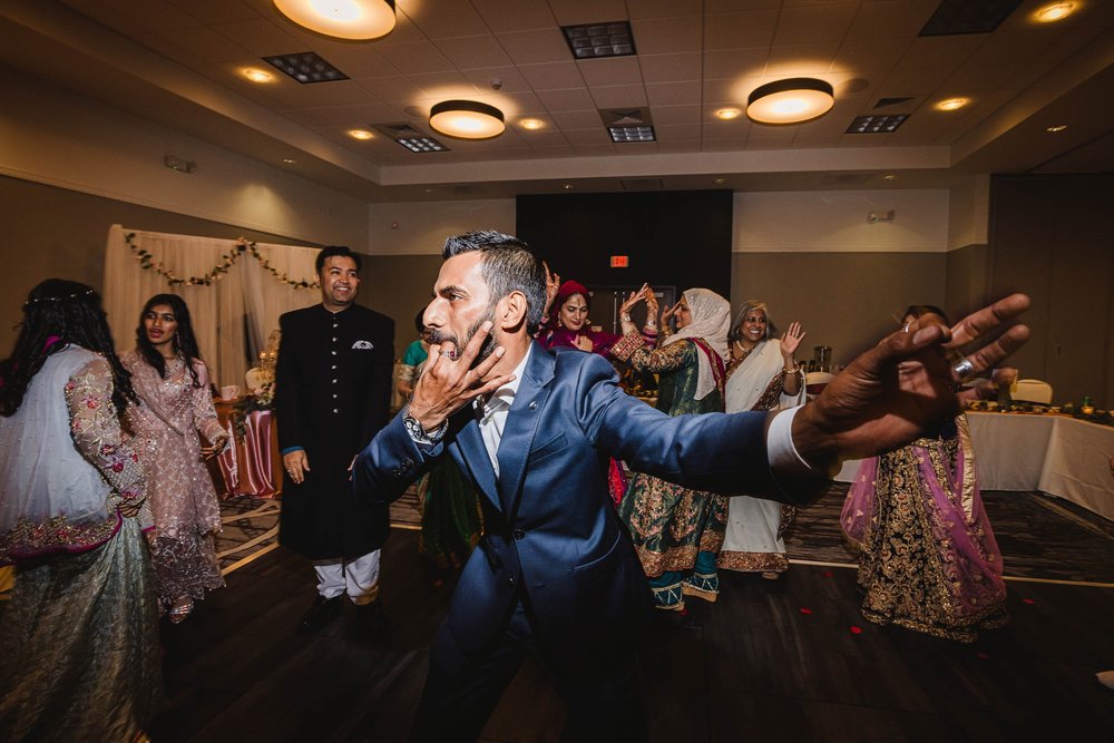 Groom dancing at Muslim wedding reception