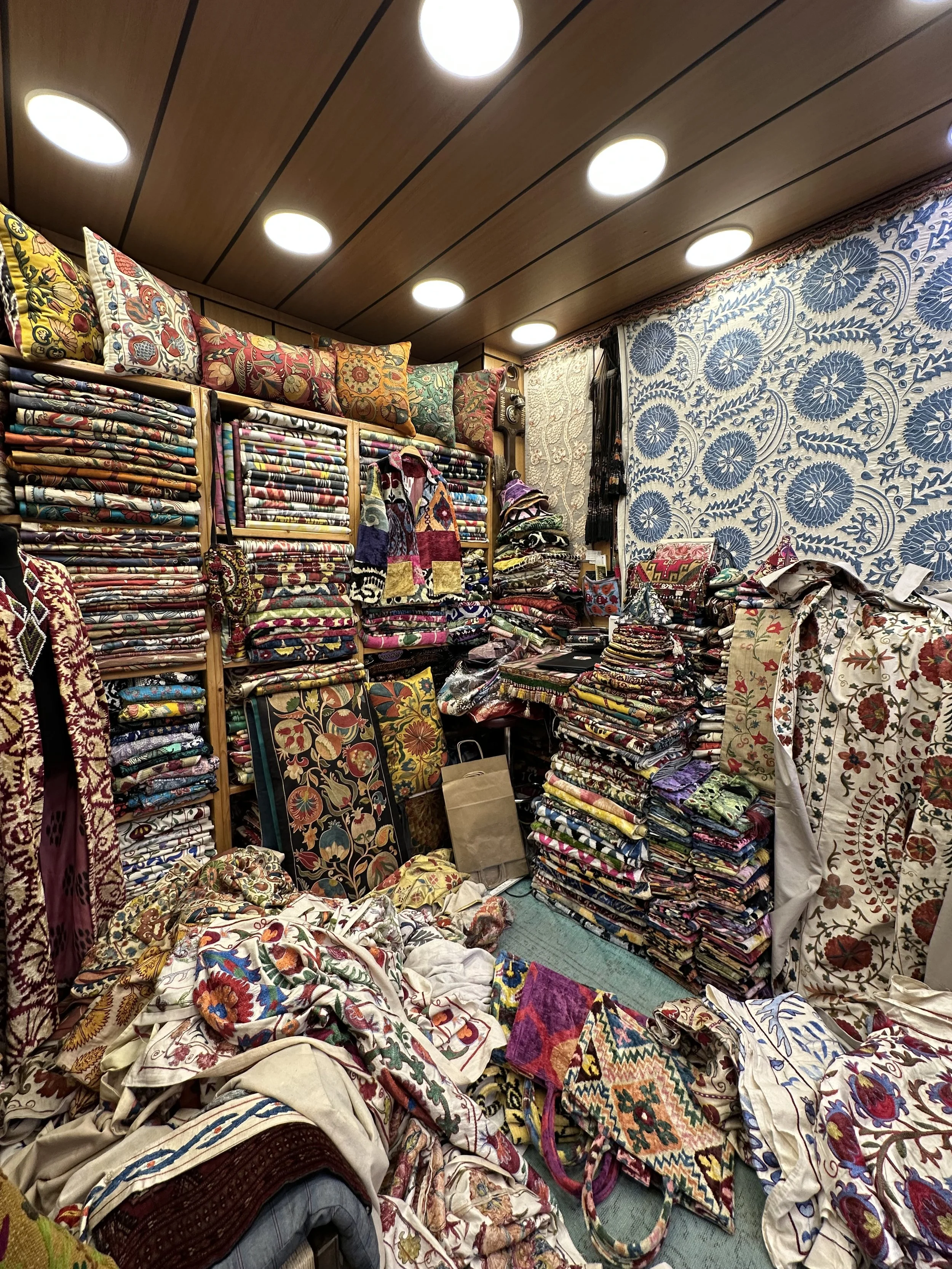 Colorful hand-embroidered Suzani textiles and decorative pieces
