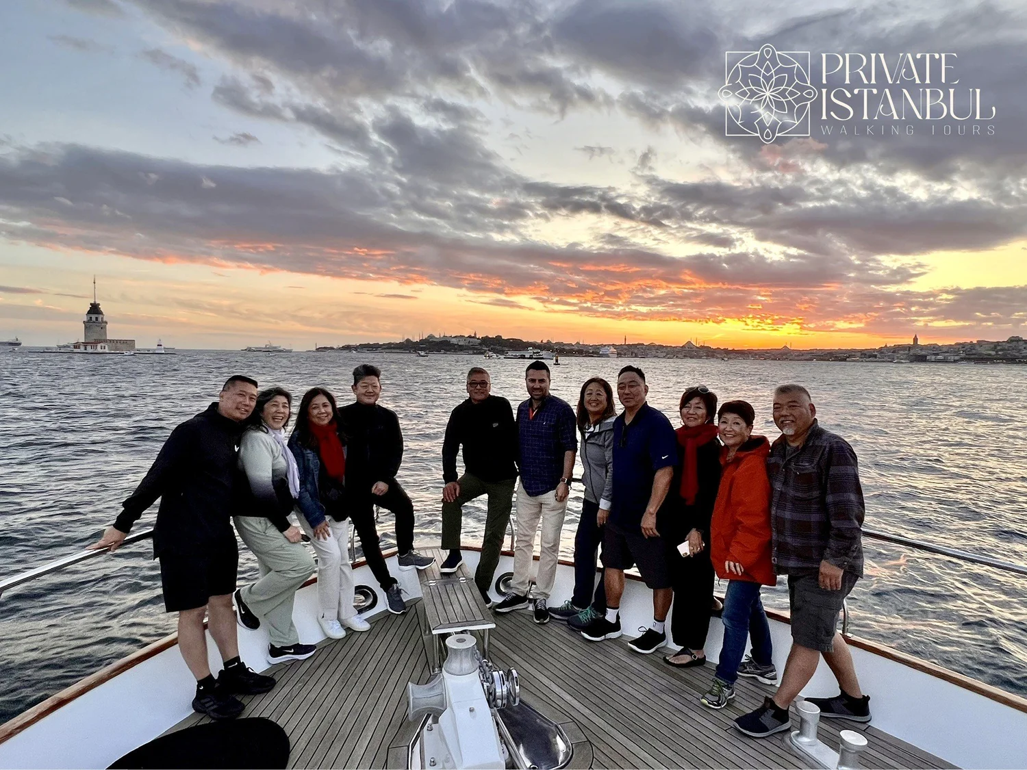 Guests on a yacht on the Bosphorus at sunset, with Maiden's Tower in the background