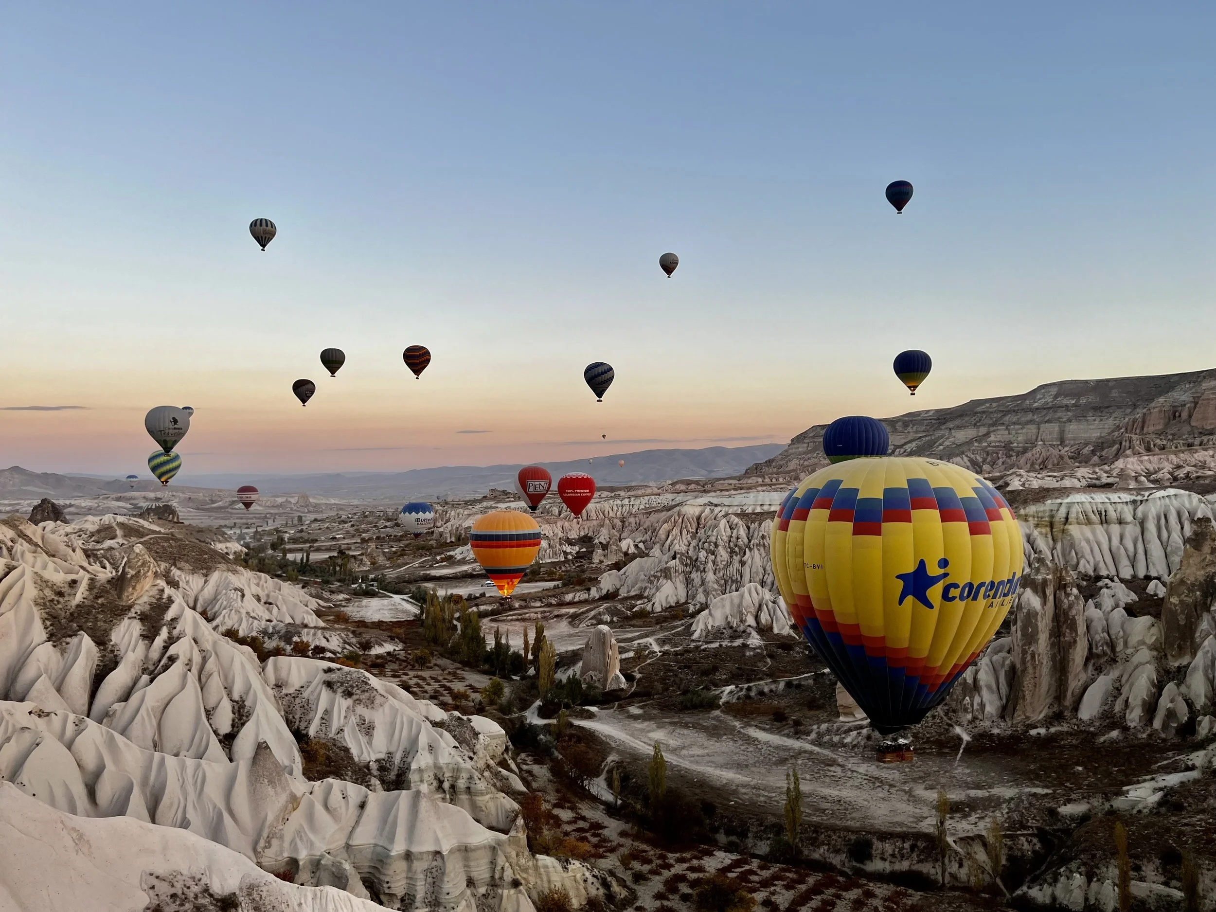 Hot-air balloons flying over the valleys of Cappadocia at sunrise