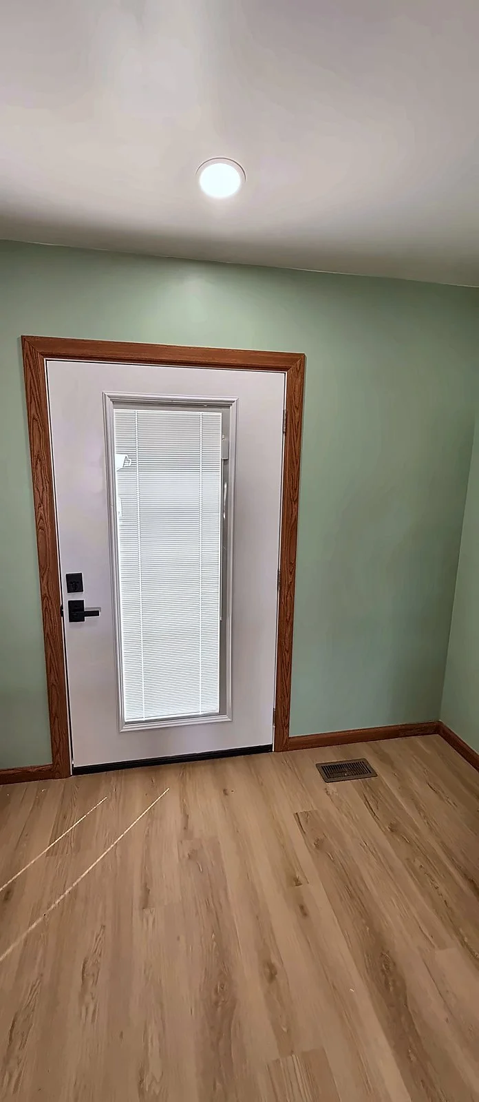Inside view of the new full-glass back door with built-in blinds, trimmed in wood casing