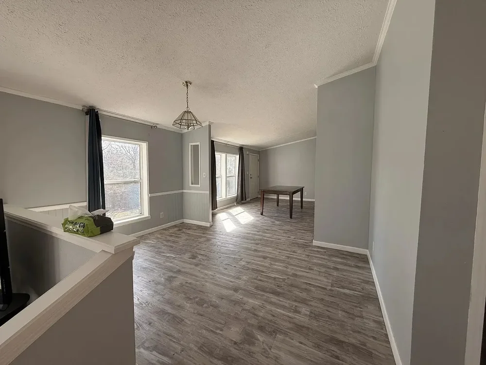 Room with freshly painted gray walls and new wood-look floor