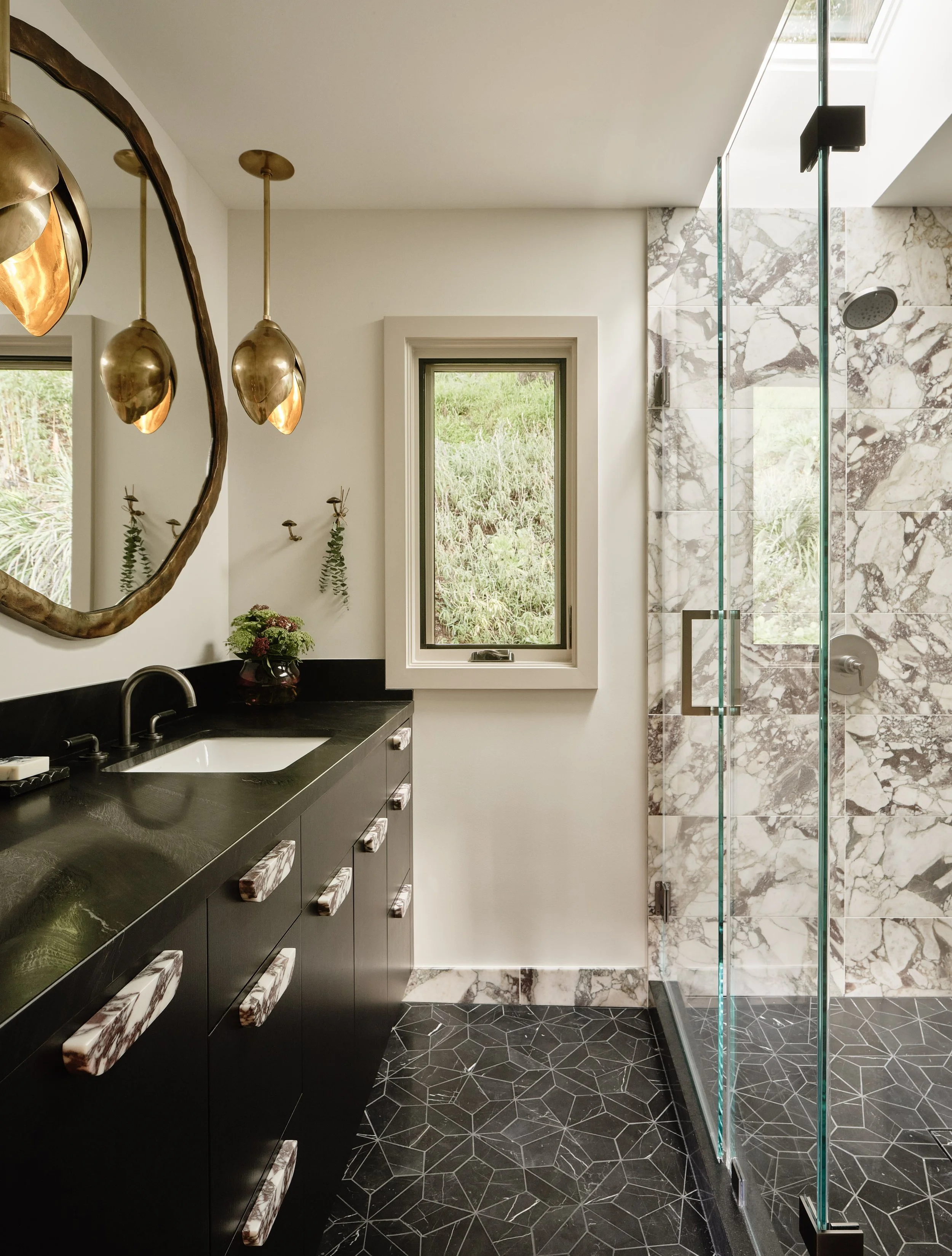 	
Holly A Kopman designs' Kentfield bathroom with marble, tile and statement lighting.