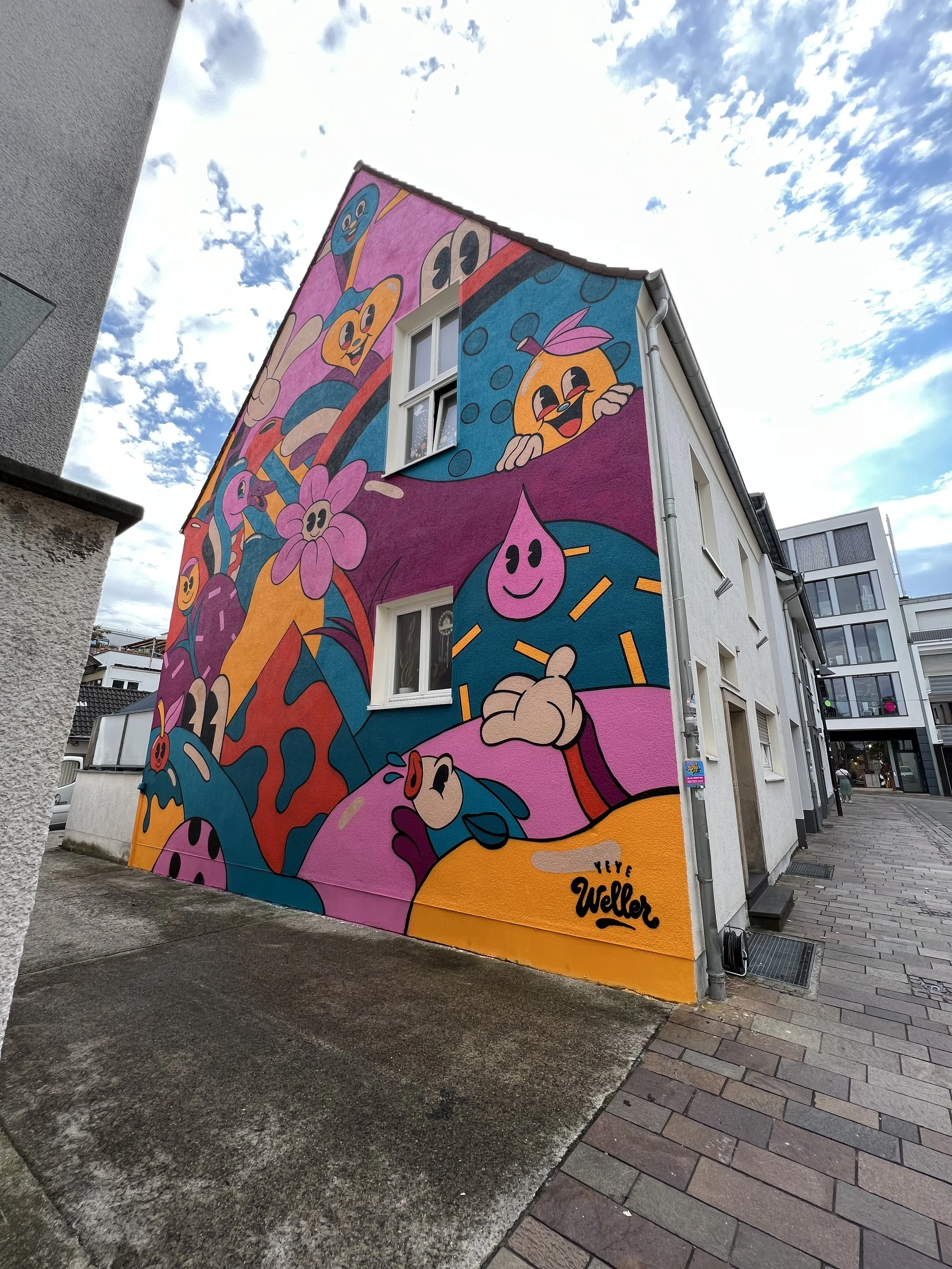 Mural by Yeye Weller, a bold, colorful, and joyful artist duo from Münster, Germany and represented by Totally Reps.