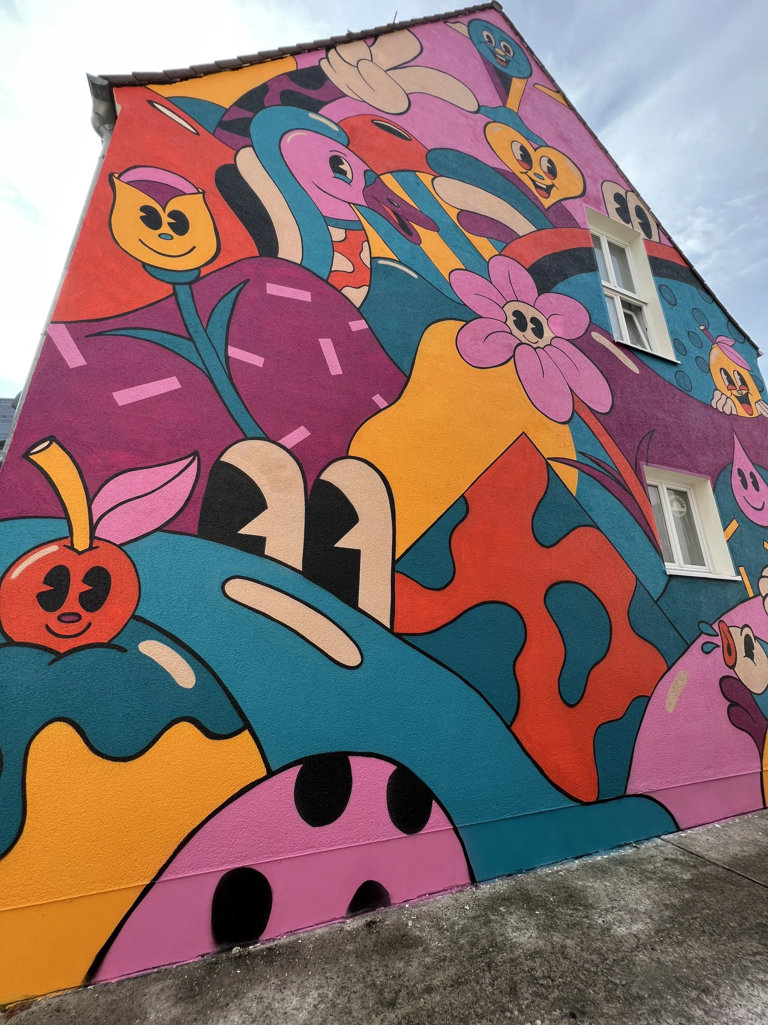 Mural by Yeye Weller, a bold, colorful, and joyful artist duo from Münster, Germany and represented by Totally Reps.
