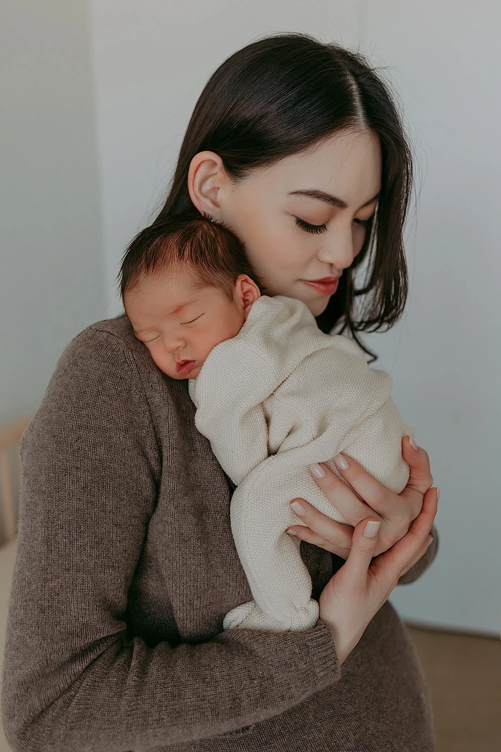 Mama and baby pose for newborn session