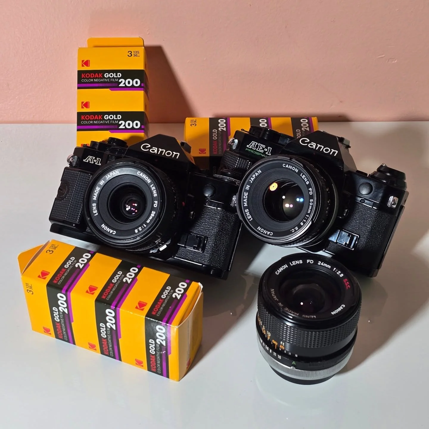 Probably the most well-known film camera in the community, the Canon AE-1 &amp; AE-1 program has easy-to-use features and is a go-to for beginners and professionals alike. Whether you shoot manually or on auto, this camera can do it all. DM us for mo