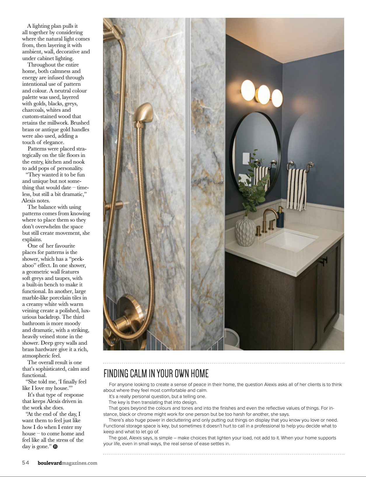 Bathroom with a dark wall, wall-mounted round mirror, brass fixtures, planter on vanity, stripe towel on hook, shower with marble-like tile, and lighting above mirror.