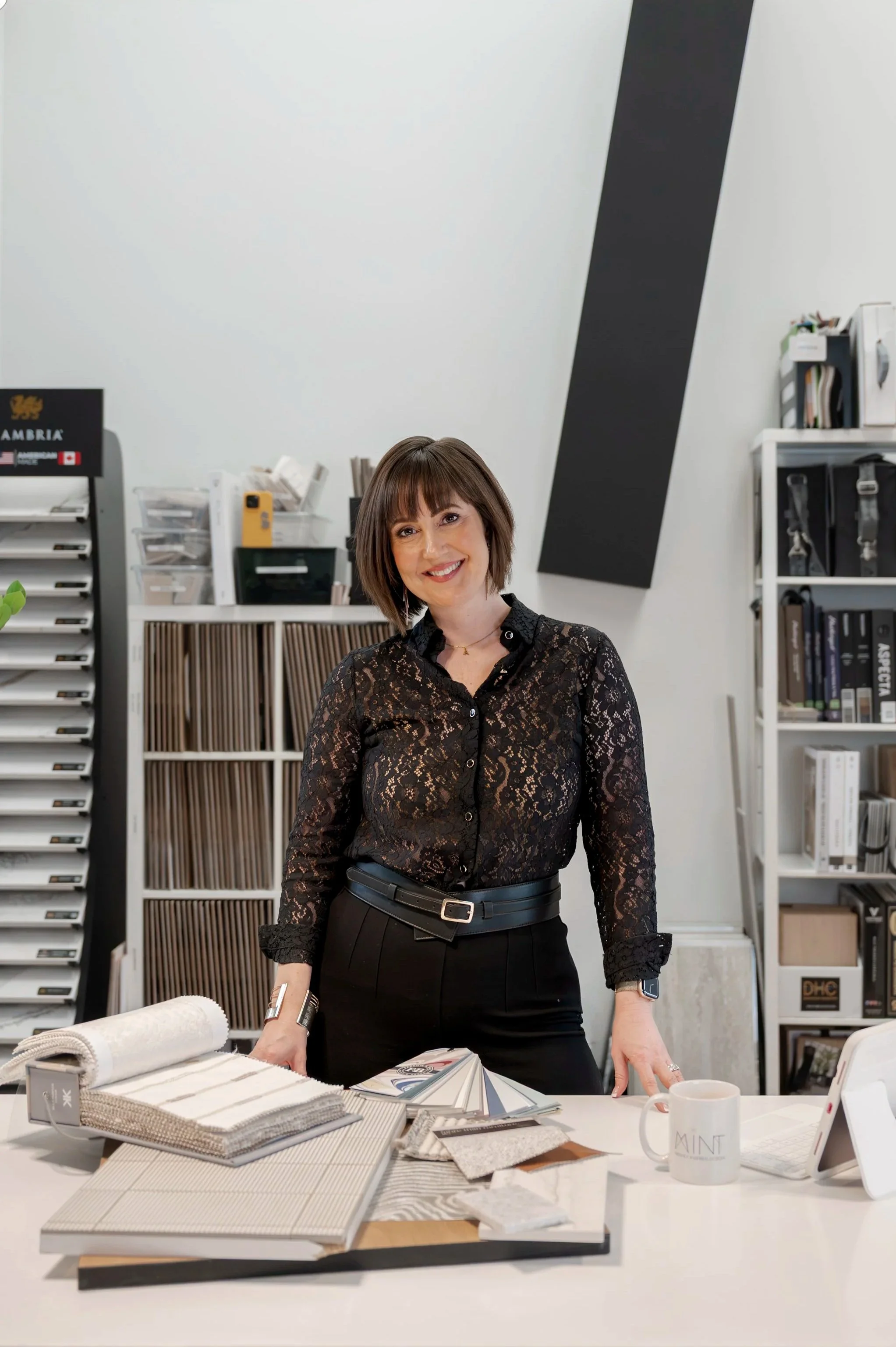 Alexis Solomon, Principal Designer and Founder of MINT Freshly Inspired Design in Victoria, BC, standing in her design studio surrounded by material samples and finishes.