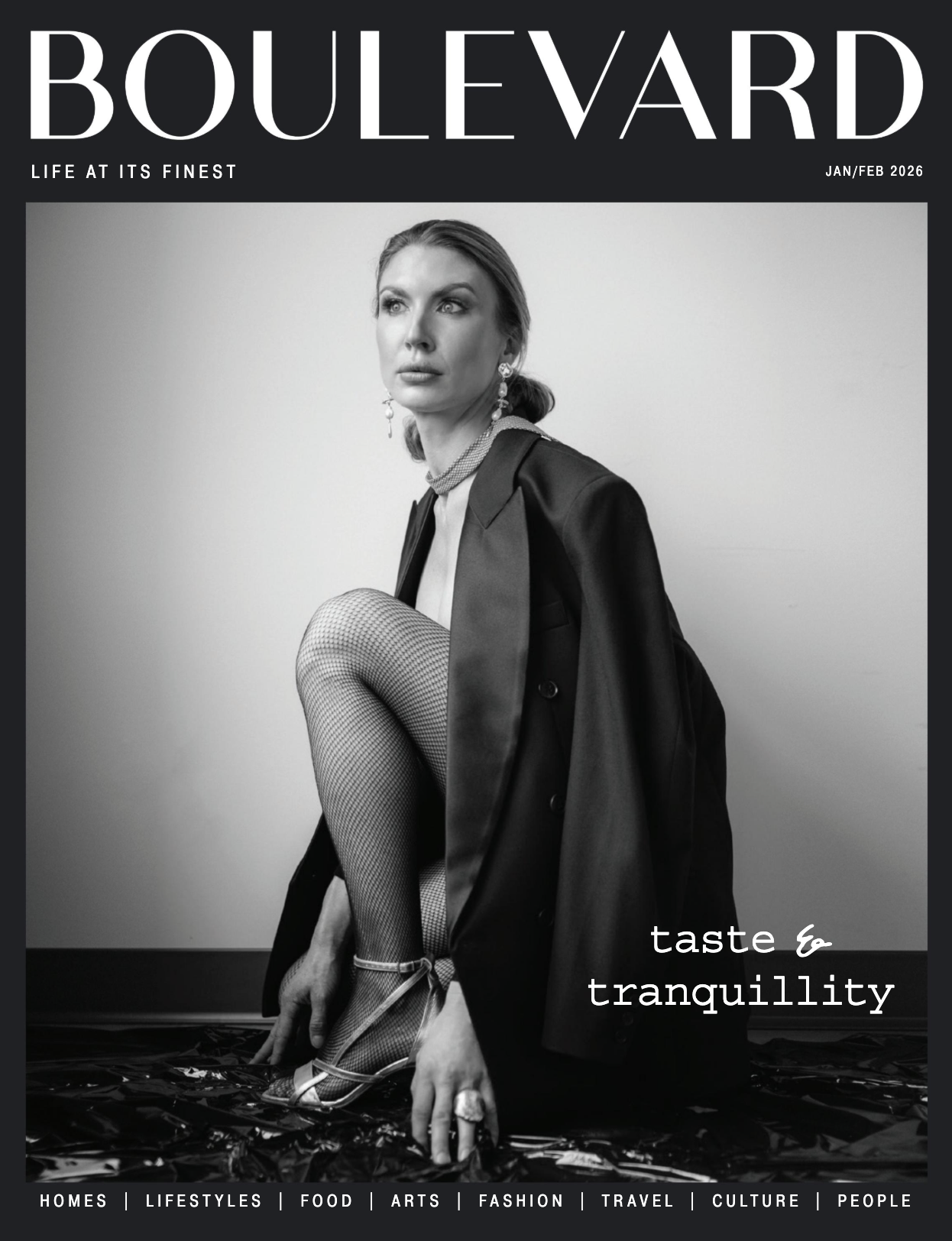 Black and white magazine cover titled "BOULEVARD" featuring a woman in elegant clothing and fishnet stockings, sitting on the floor with one leg raised. She is wearing jewelry and high-heeled shoes. The cover includes the text "taste & tranquility" and mentions topics like homes, lifestyles, food, arts, fashion, travel, culture, and people. The date is January/February 2026.