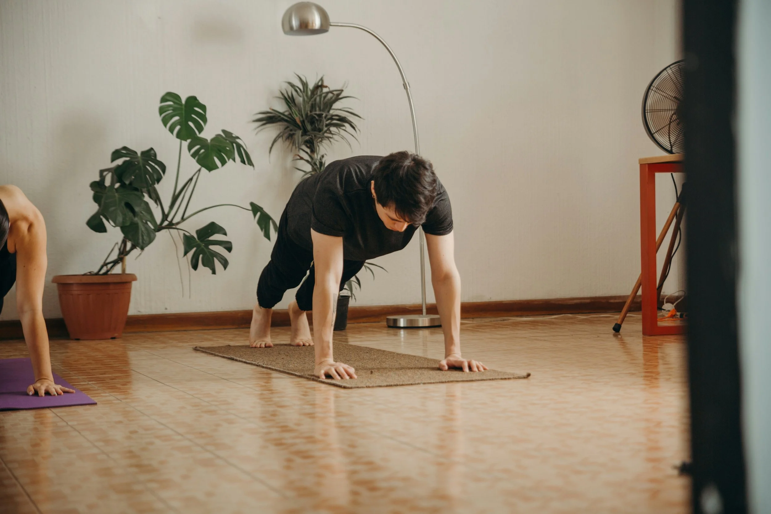 Man stretching in yoga class | How to Prioritize Your Health | Scarlet Oak Wellness