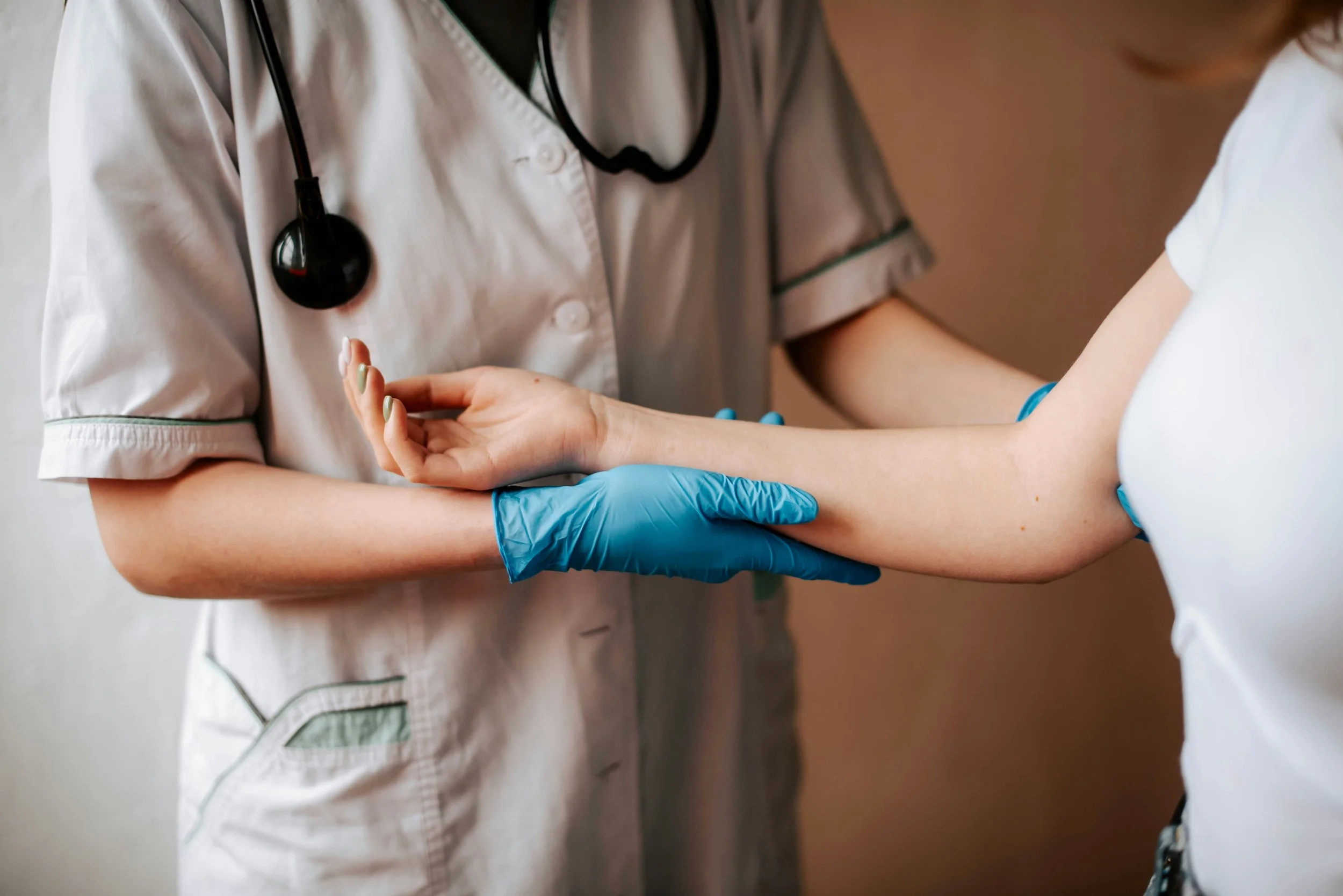 Doctor holding womens arm, getting ready to do blood work | Check thyroid function, iron levels, vitamin deficiencies, and other medical concerns as it can point to perimenopause | Scarlet Oak Wellness