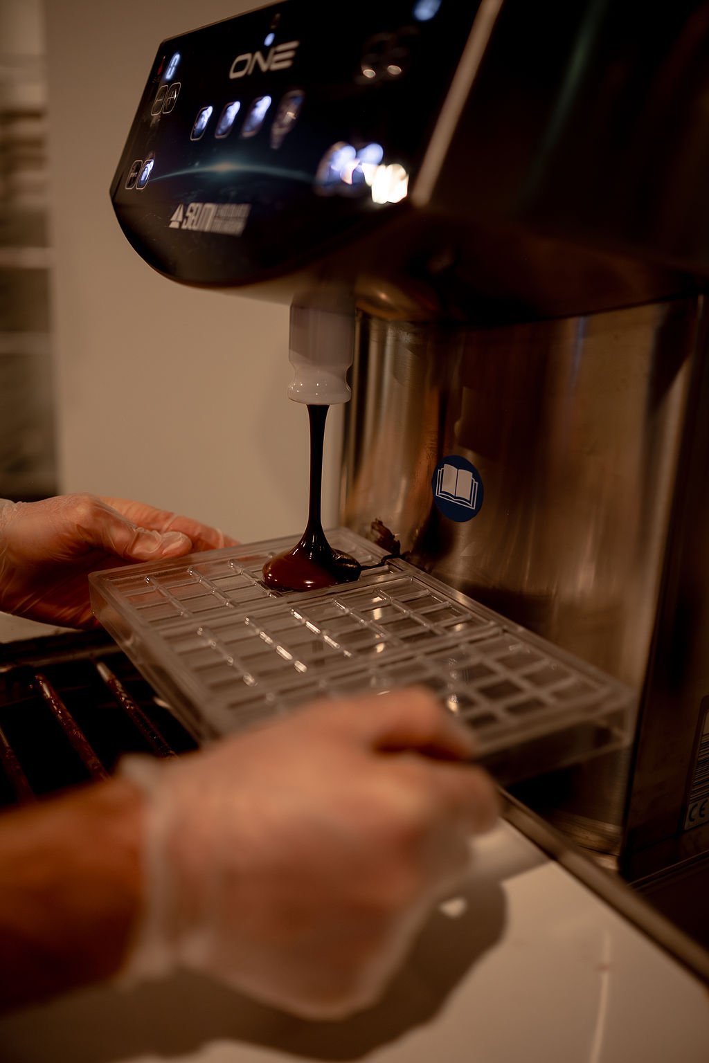 Founder and Chocolate Maker, Antoine Lavoie, moulding tempered chocolate into bar forms at Delavoye Chocolate Maker