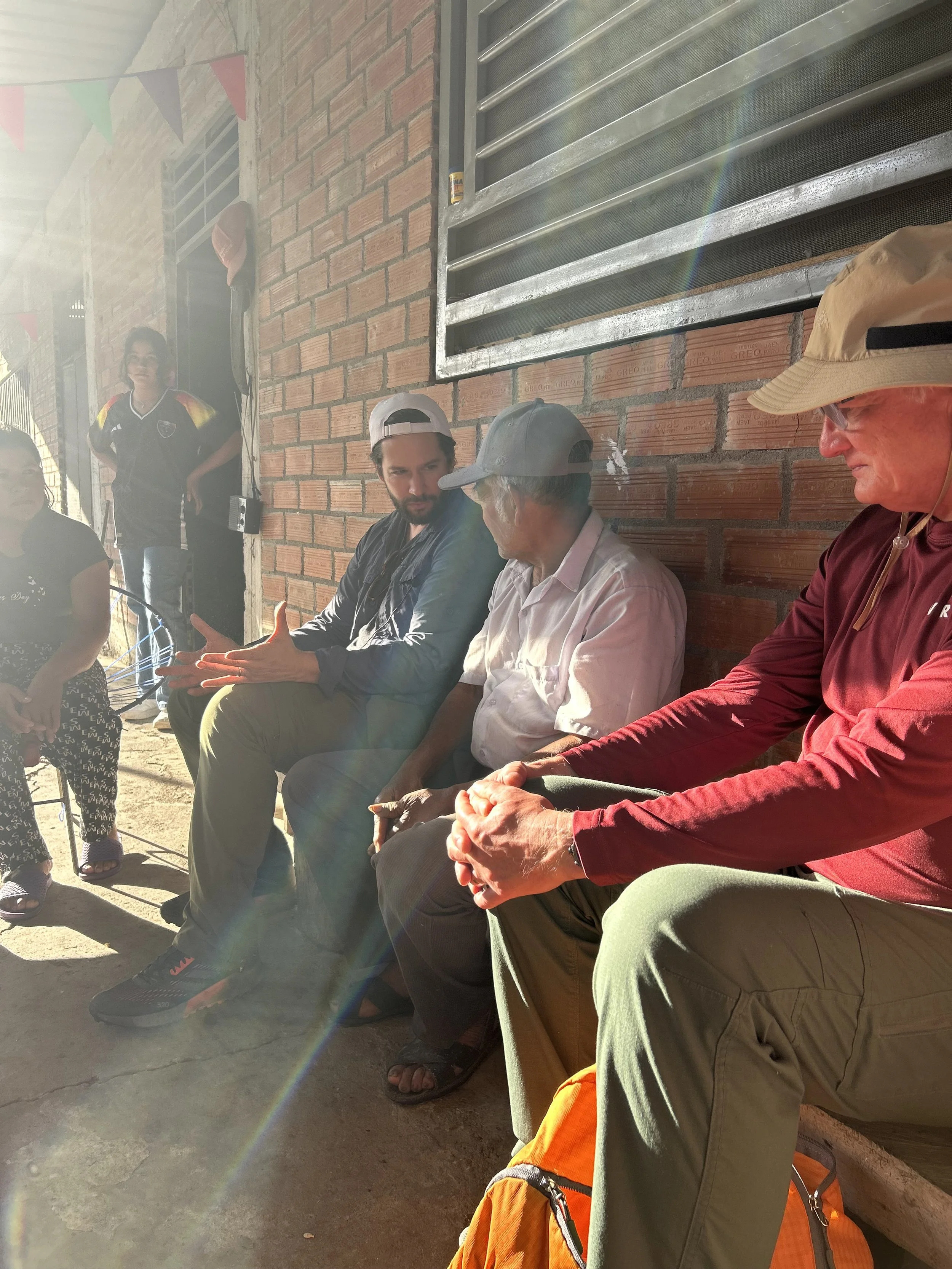 Sunlit porch conversation at Don Fortunato's finca in Huarango, Peru