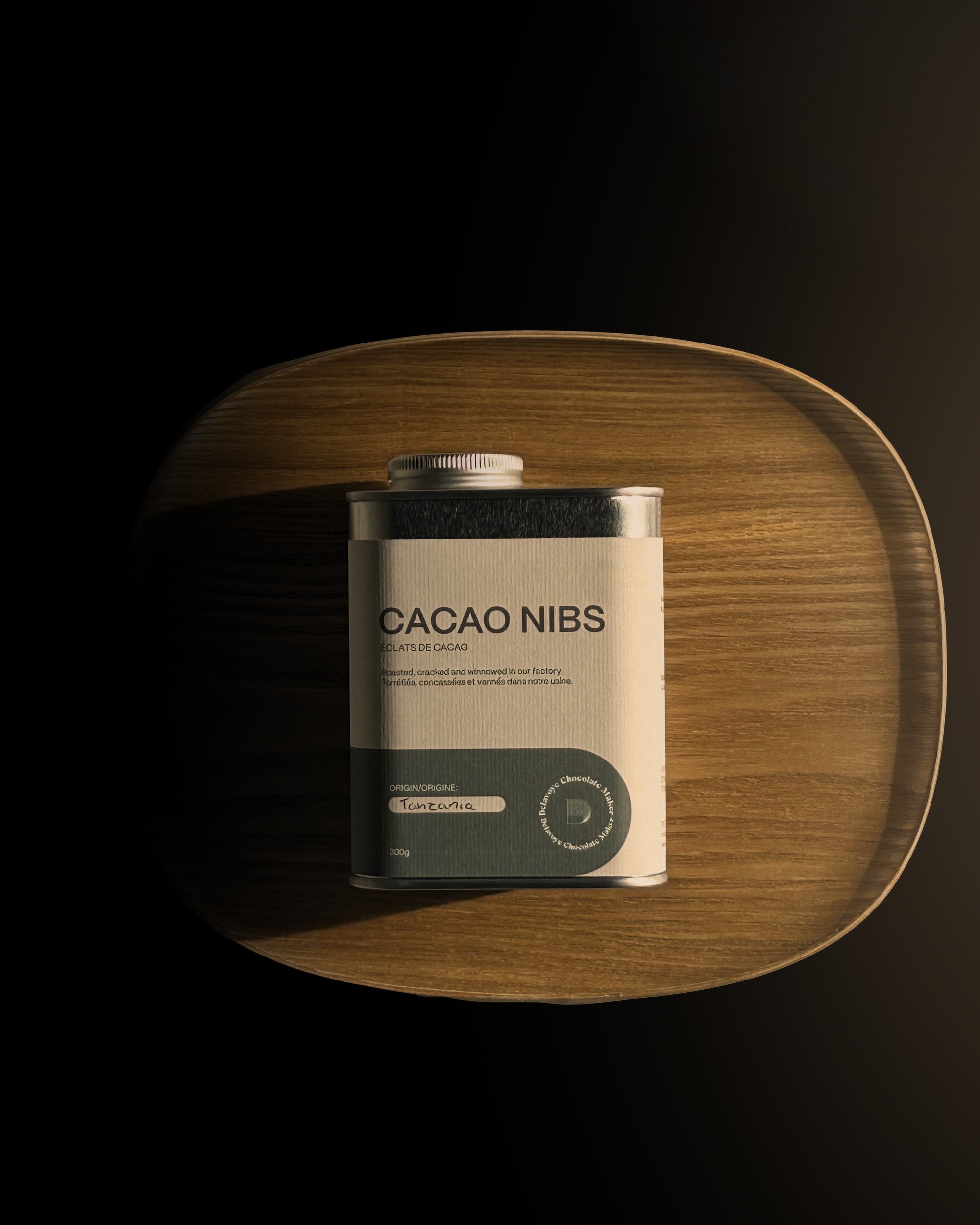 Cacao Nibs tin on a wooden tray