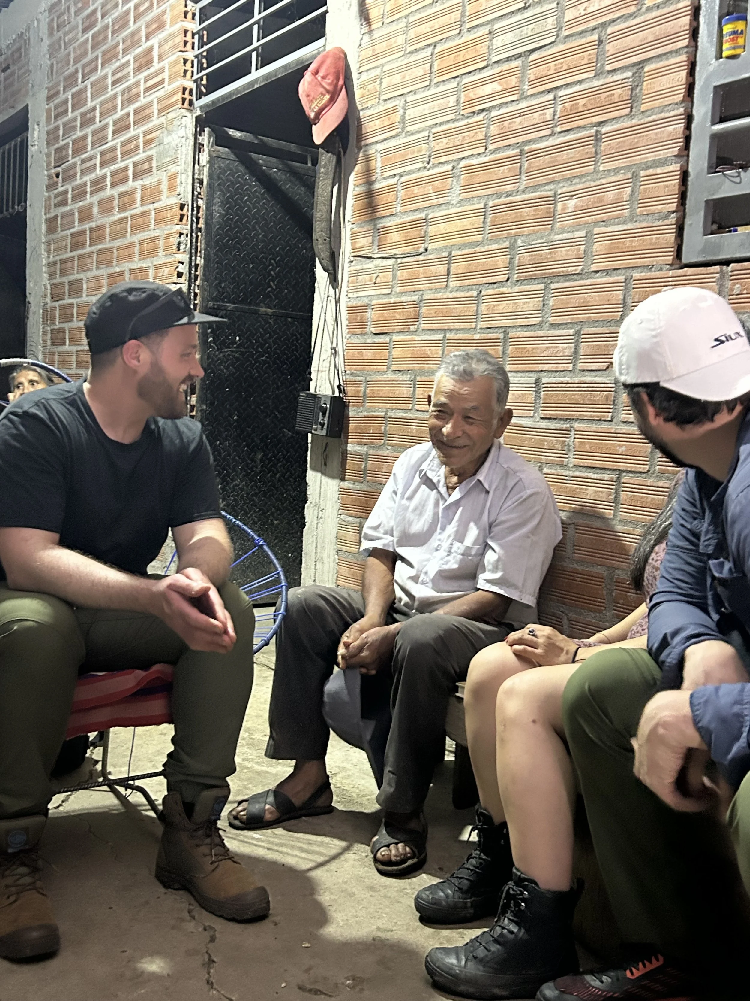Evening talk by a brick wall