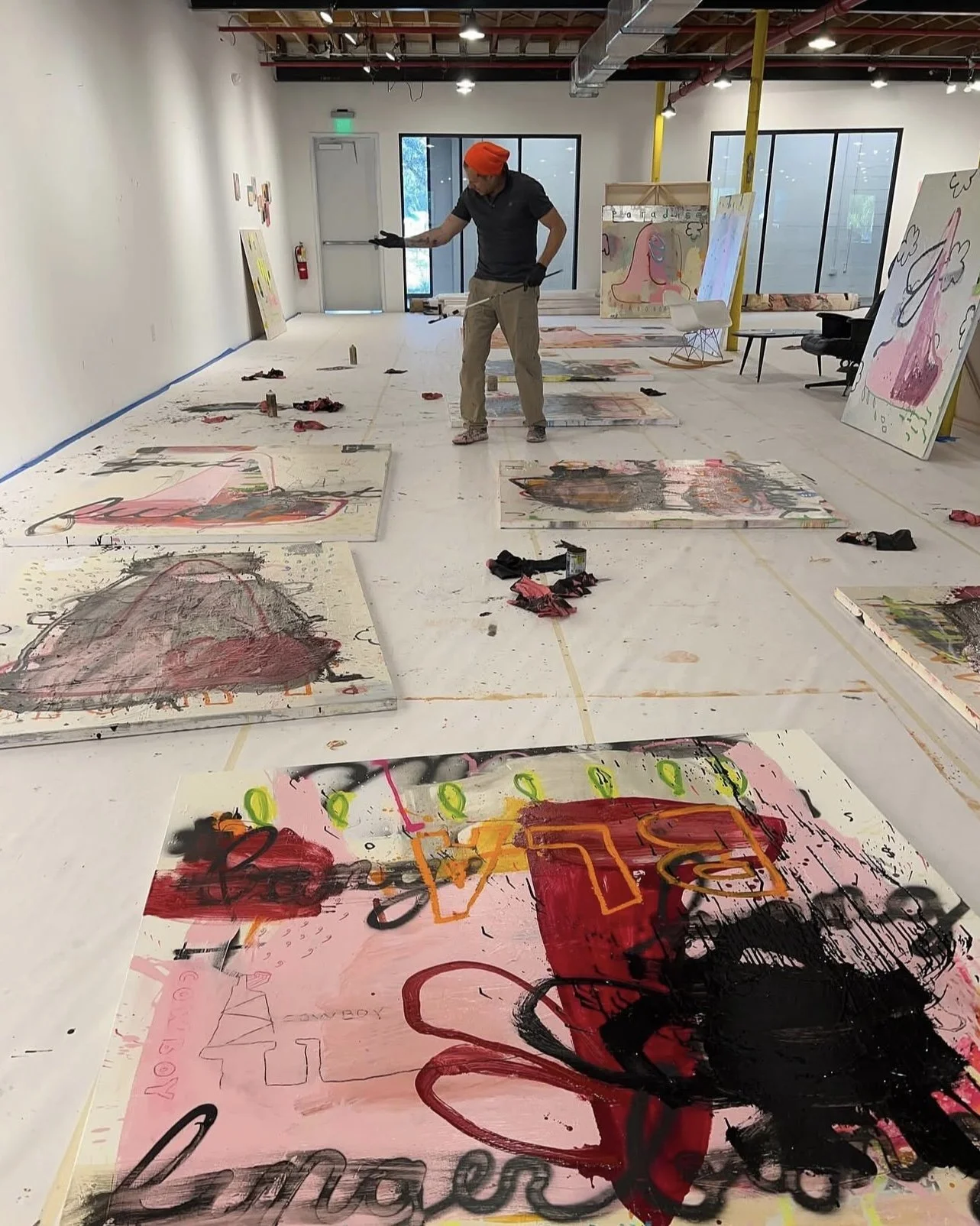 Artist Jason Hackenwerth Painting on floor of his studio