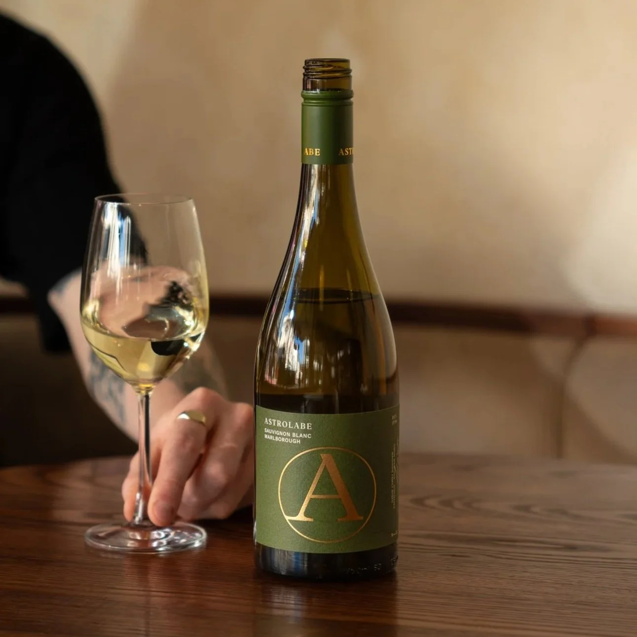 Astrolabe Sav Blanc on a table with a glass in New Zealand