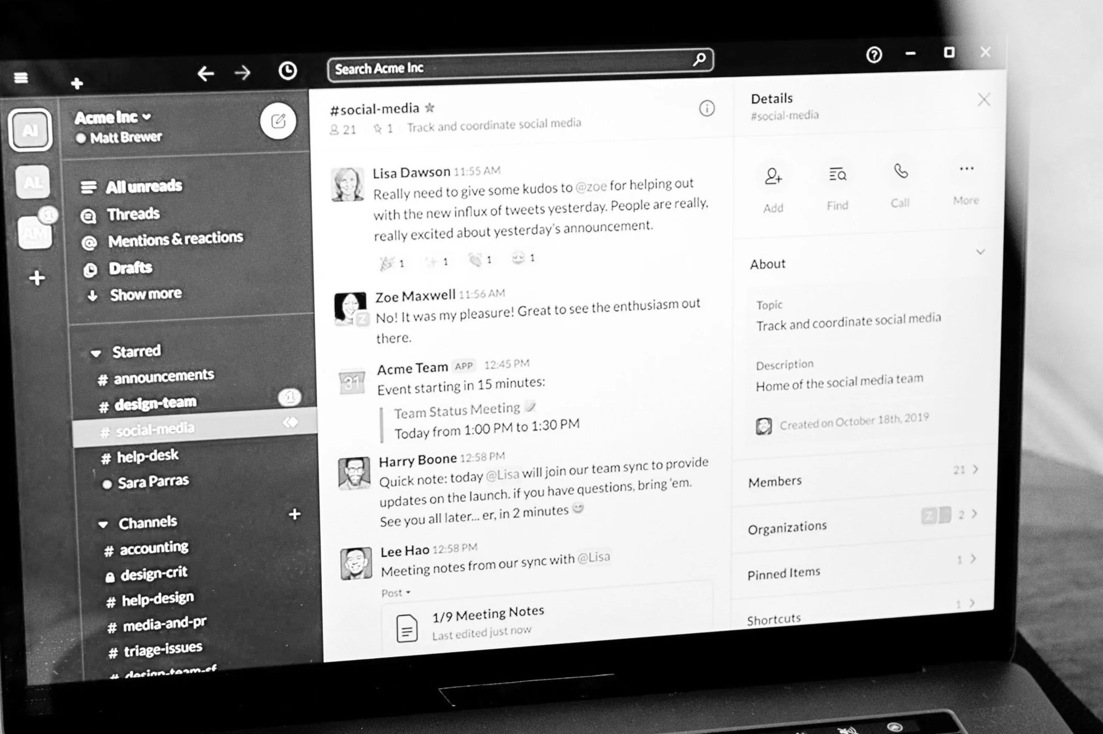 Black and white image of a computer screen displaying a Slack interface with various messages in a social media team channel.