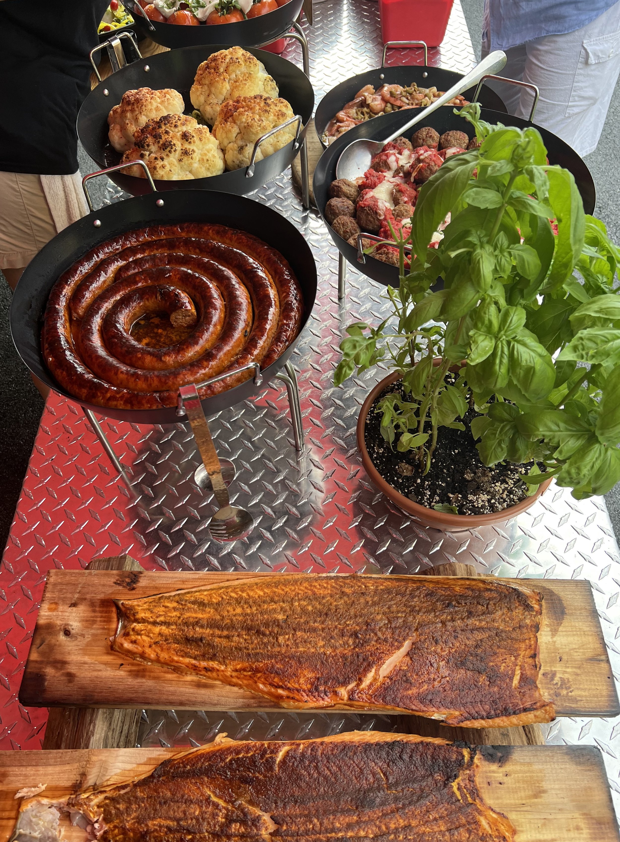 Various pans of food for pizza toppings