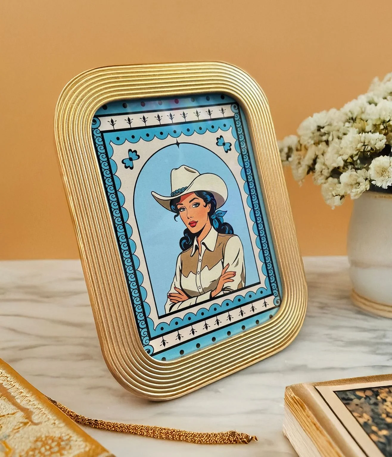 One 5x7 cowgirl art print in a mid-century modern gold frame with sculptural ridges.