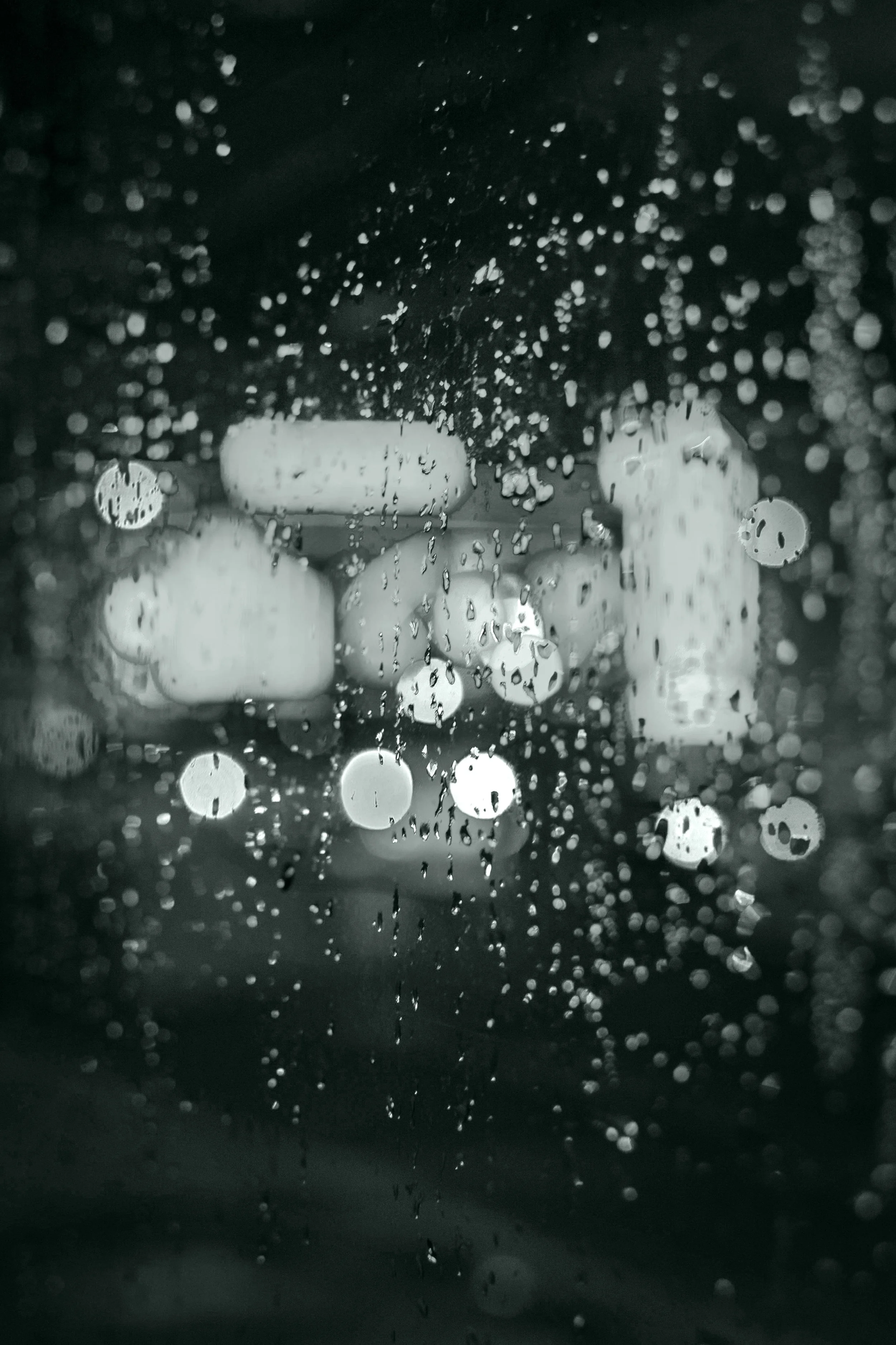 A window covered in raindrops, illustrating the lonely tone of Empire