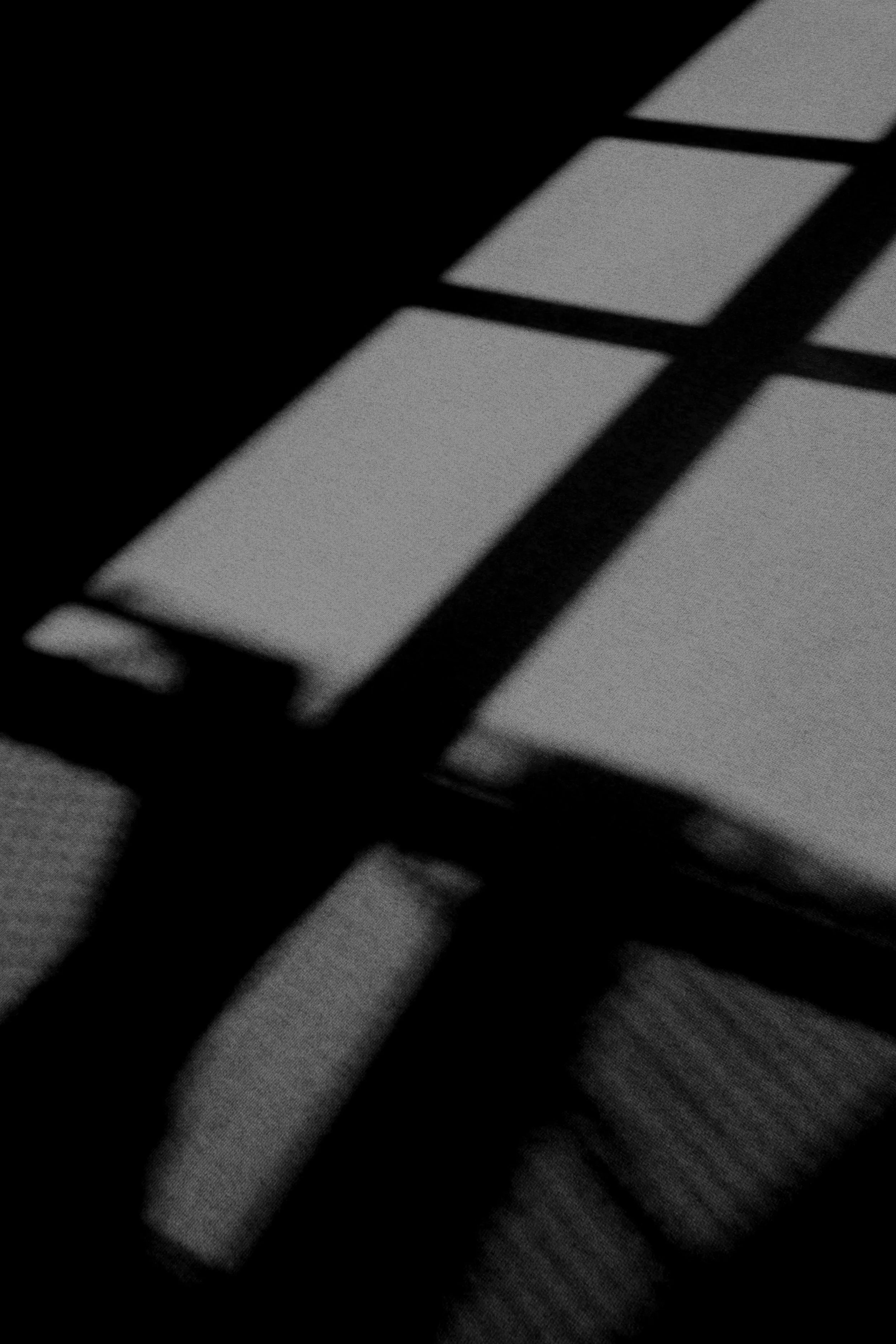 A dark room lit by the window, inspired by the seediness of the track "The Thin Line"