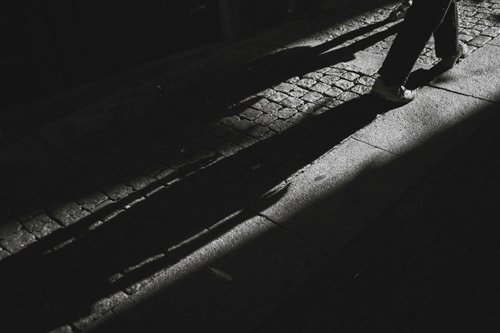 Shadowy film noir image of shadows on a sidewalk