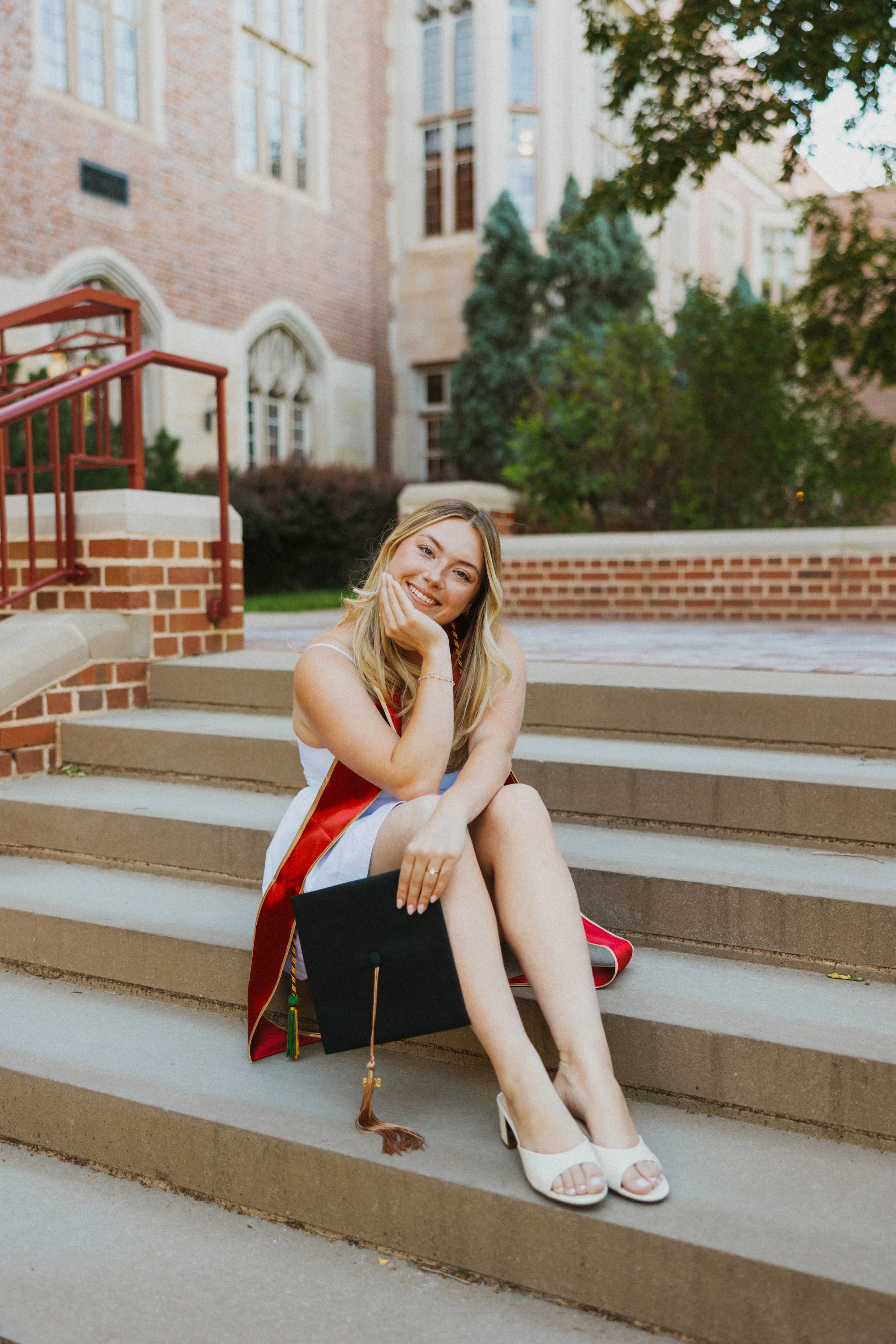 Grad sits on steps in front of Mary Reed at DU