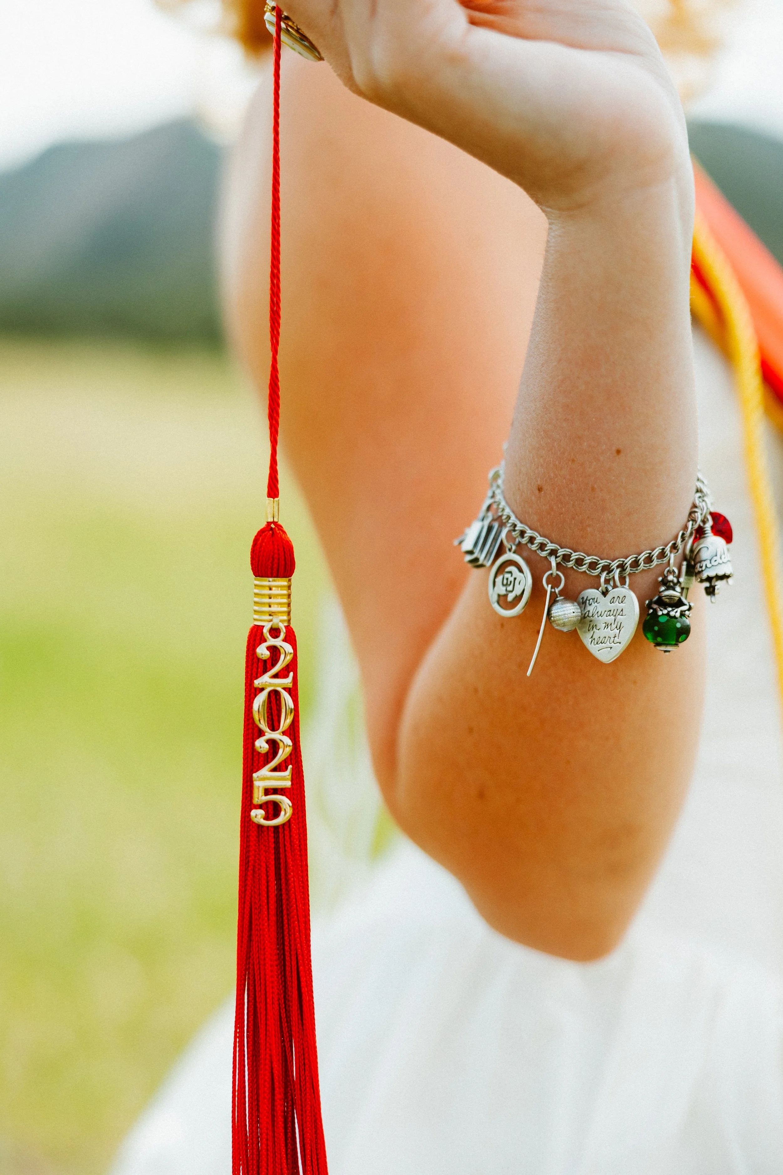 Details with tassel and charm bracelet