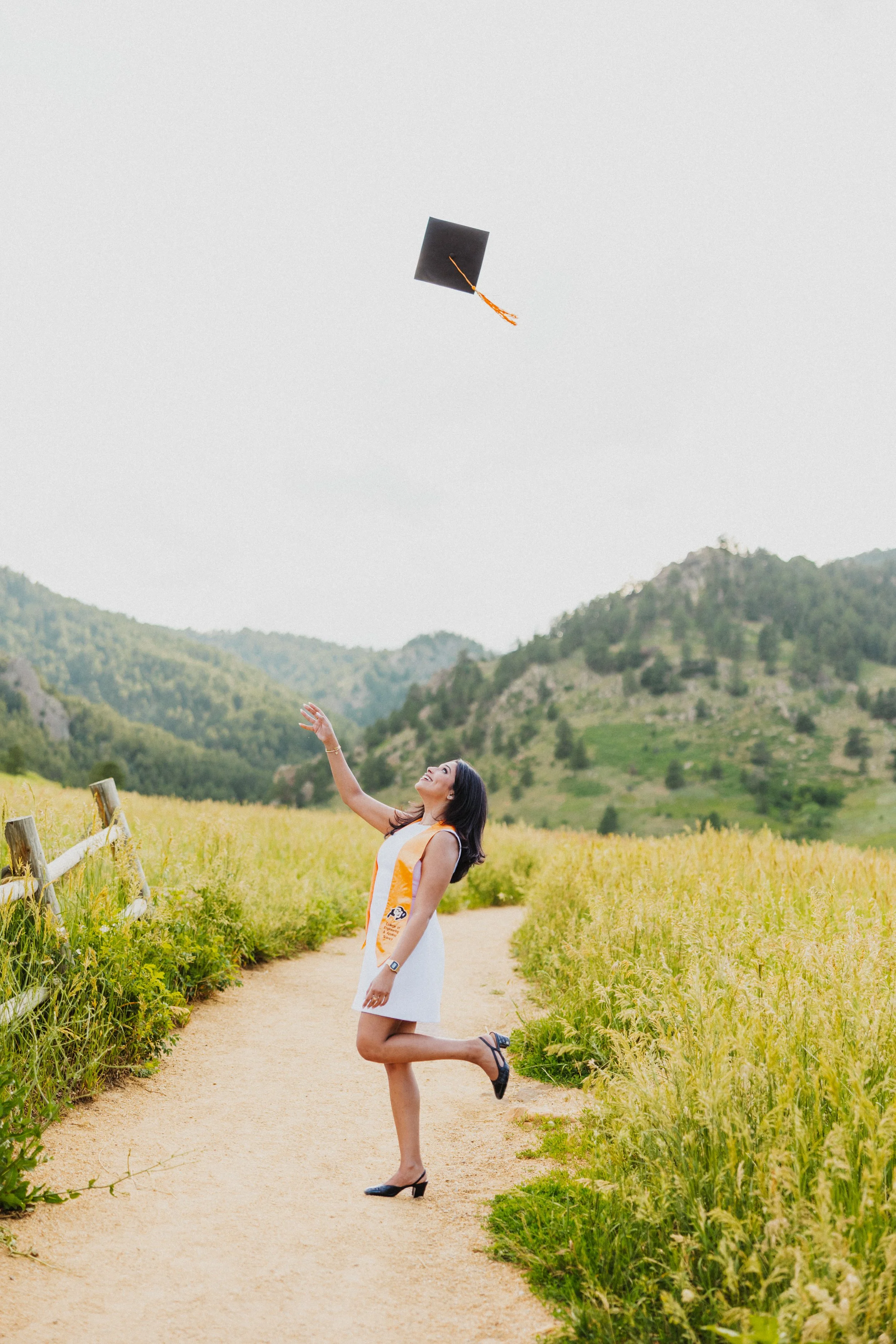 Grad tossing cap in air at Chautauqua Park, Colorado