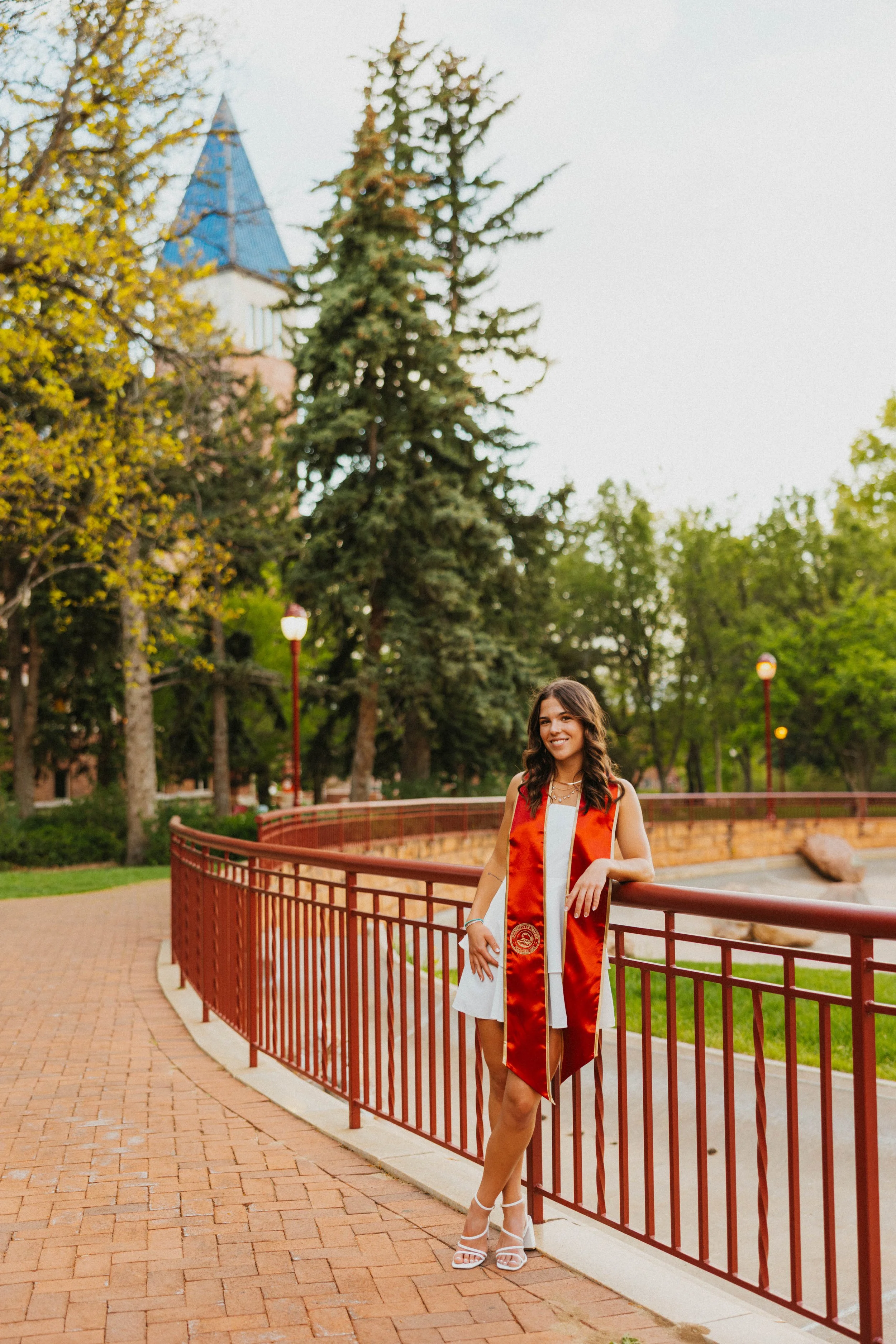 Senior leaning against railing at University of Denver