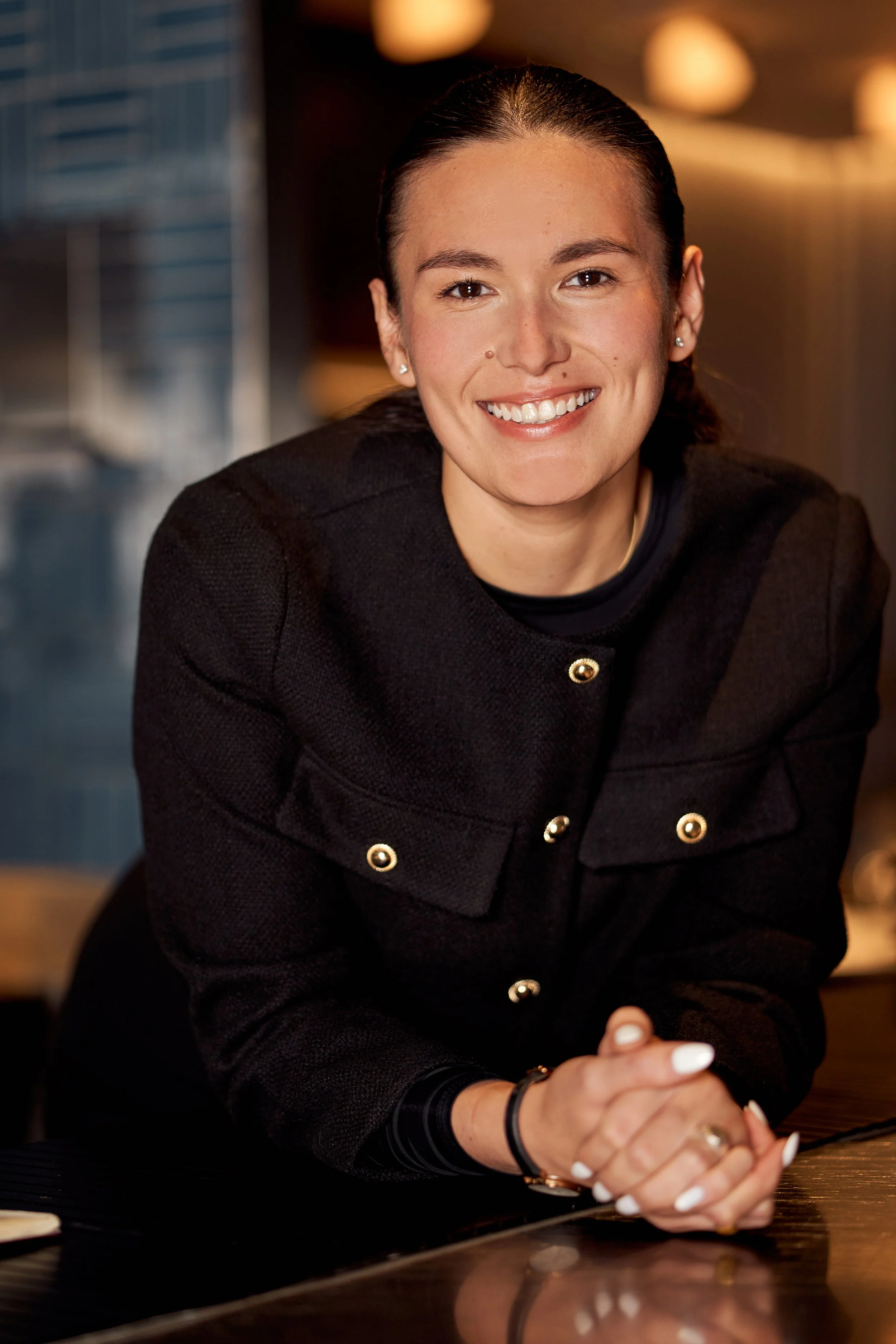 Abbi, MONO's warm and attentive Assistant Manager, greeting guests in the dining room