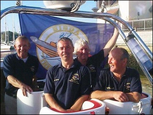 Celebrating Round Britain and Ireland record. 2005. Celebrating returning from 1,975 miles round Britain and Ireland. Gordon Compton, Chris Strickland, John Puddifoot, Jan Falkowski.