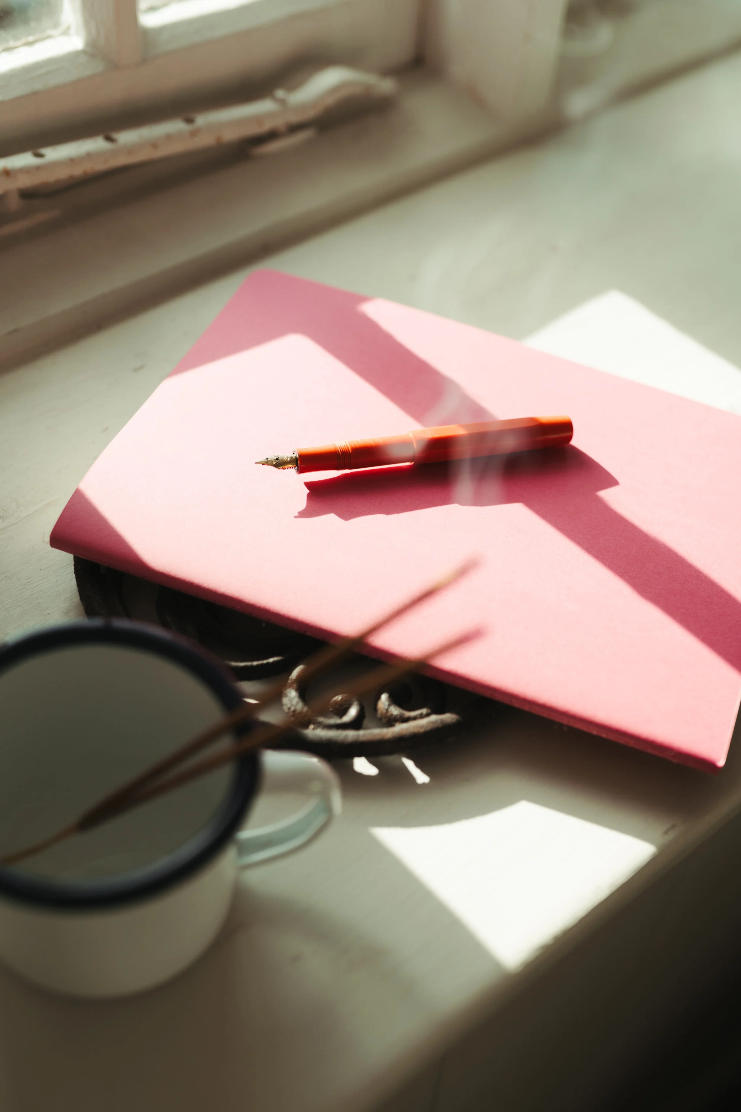 A person holding a stack of nine books with colorful covers, featuring titles on writing, marketing, storytelling, and creativity.