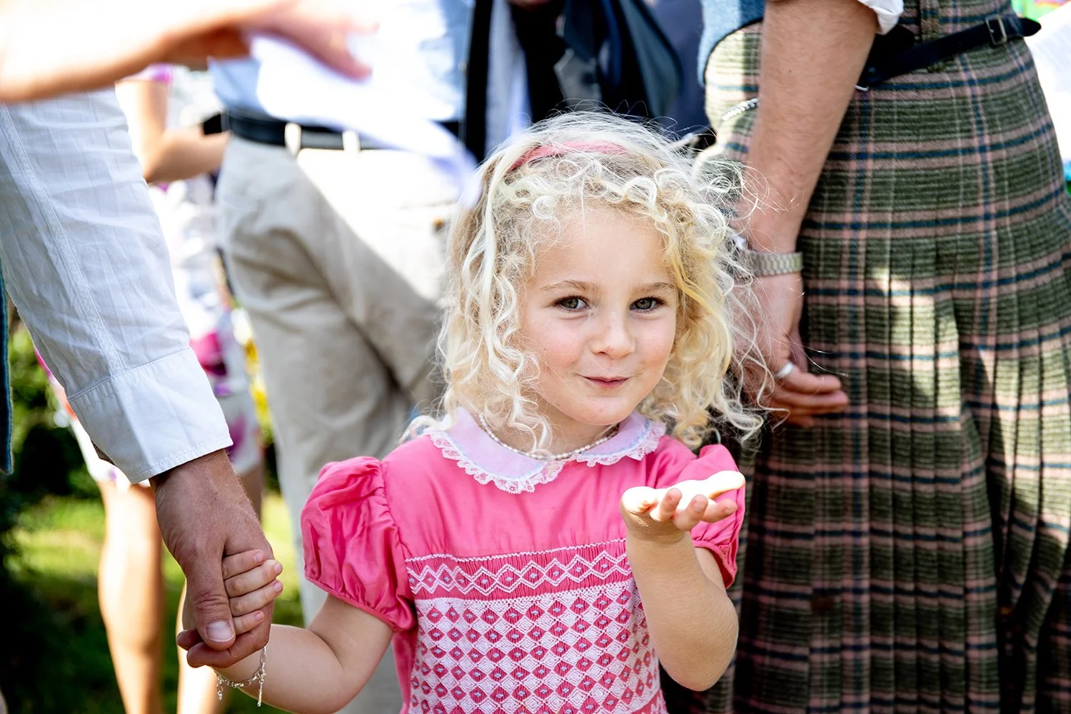 child blowing a kiss at wedding